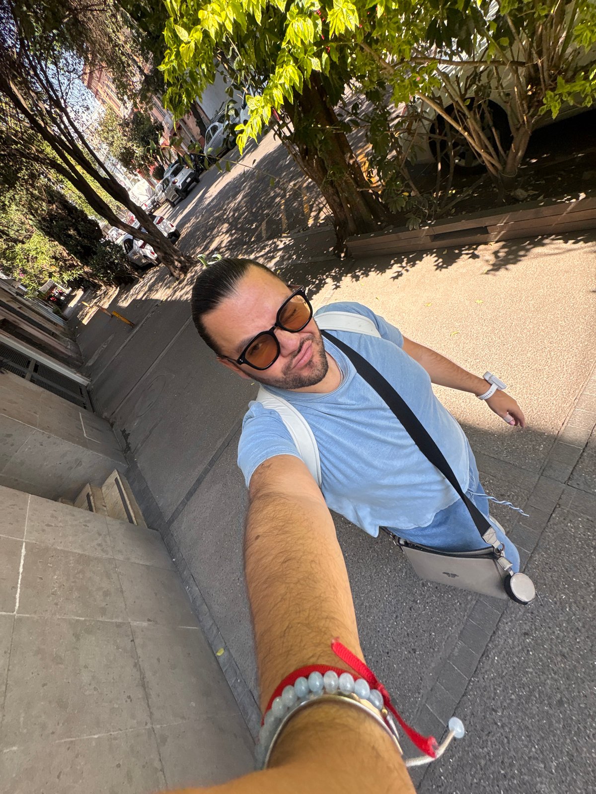 Person documents sunny afternoon walk through Mexico City streets