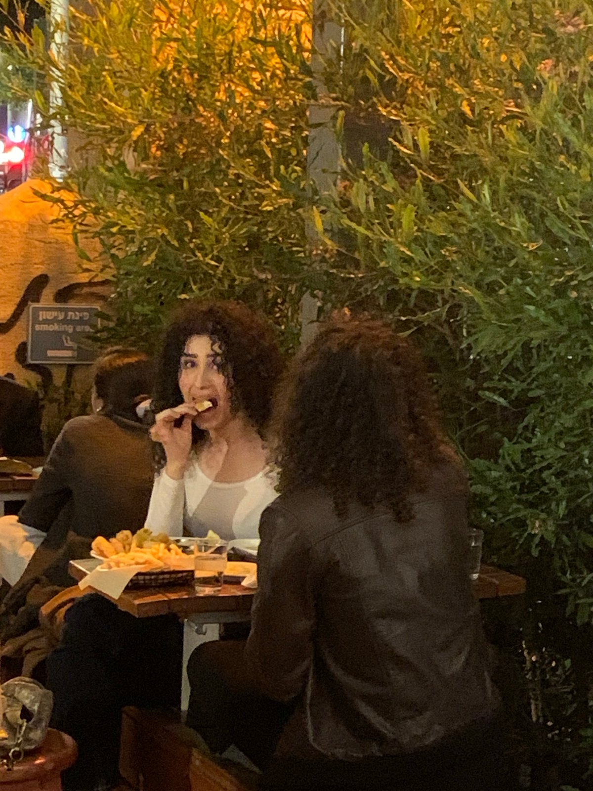 Evening outdoor dining captured at Tel Aviv restaurant