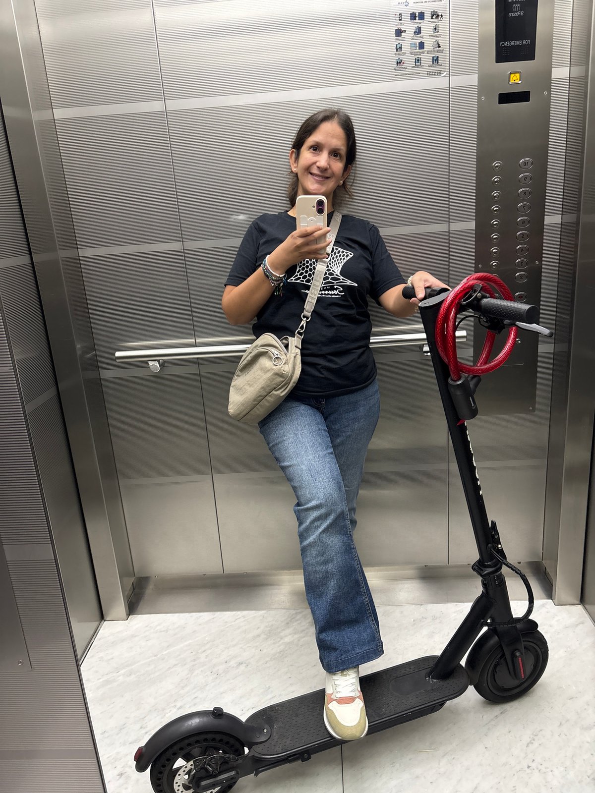Woman takes smiling elevator selfie in San Isidro