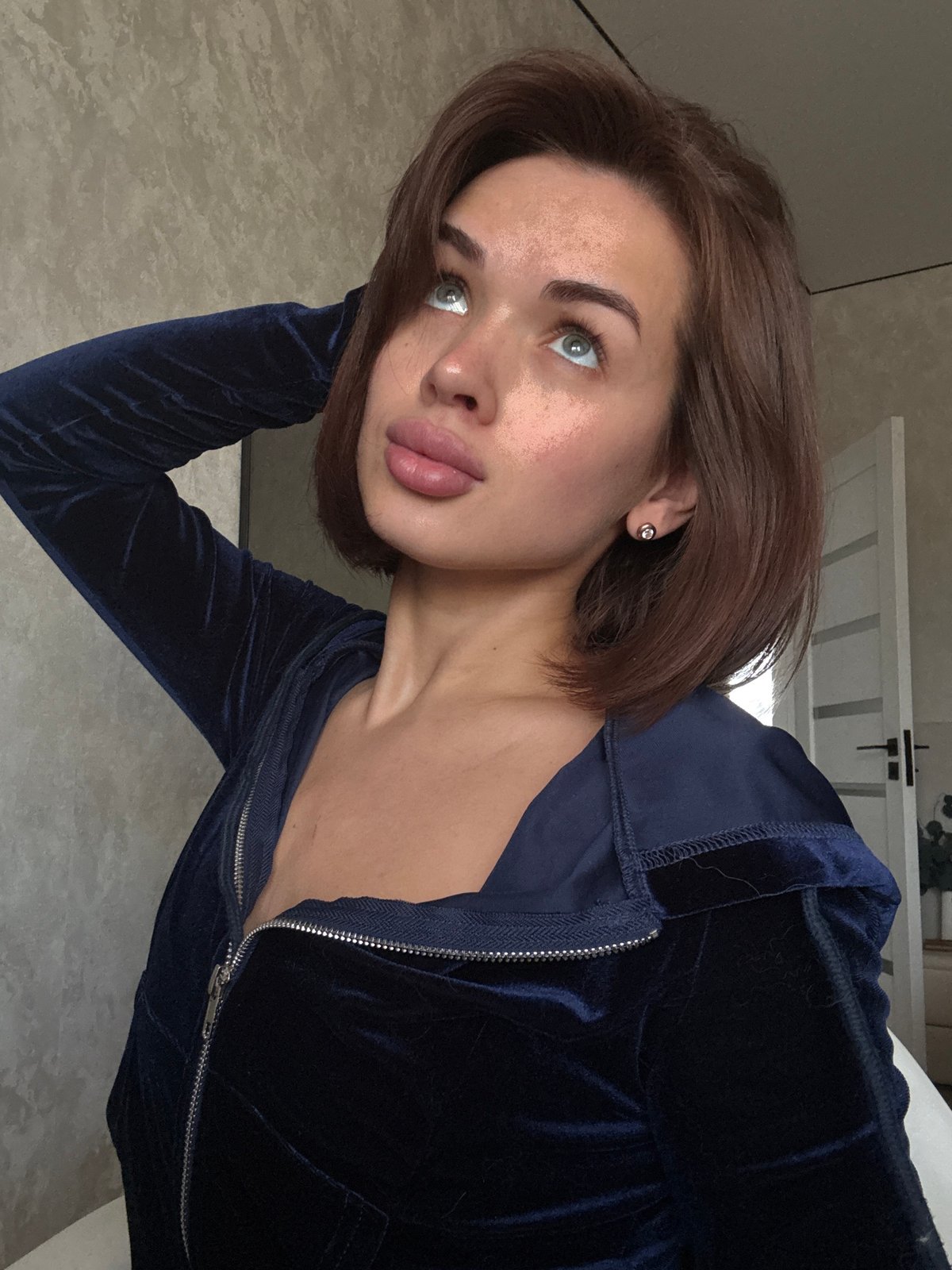 Woman poses for photos indoors in Russian village