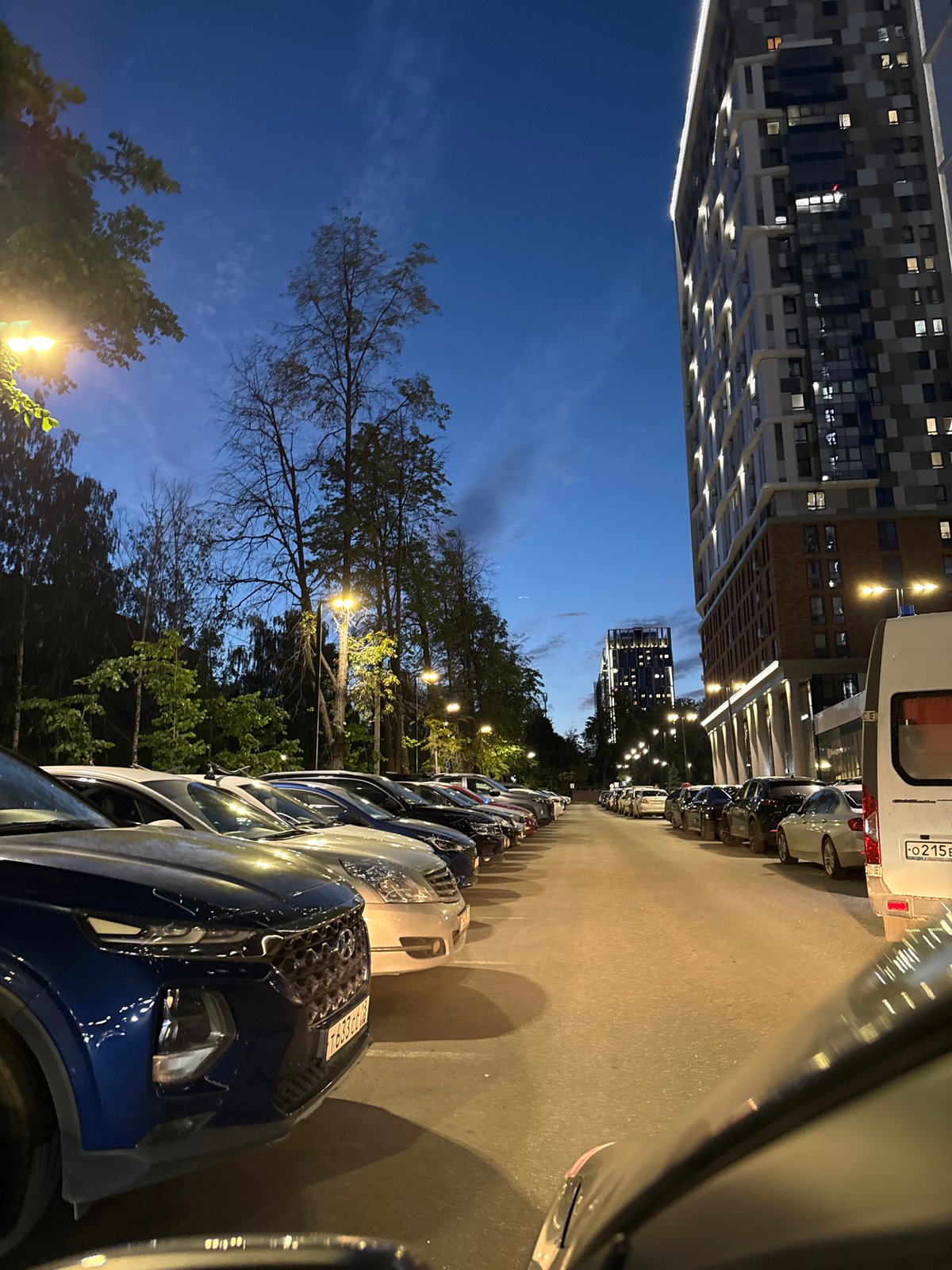 Izhevsk residential parking lot at dusk, evening light