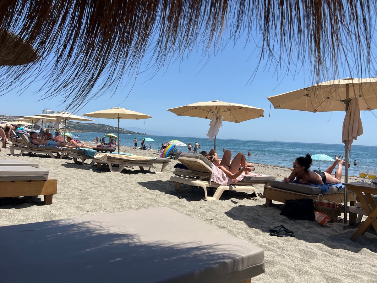 Sunny beach day at San Roque's busy shoreline