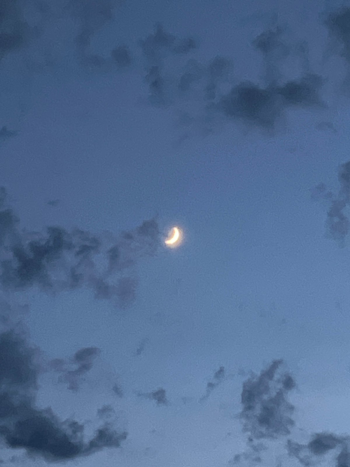 Crescent shape in cloudy Sochi sky, Moon or eclipse