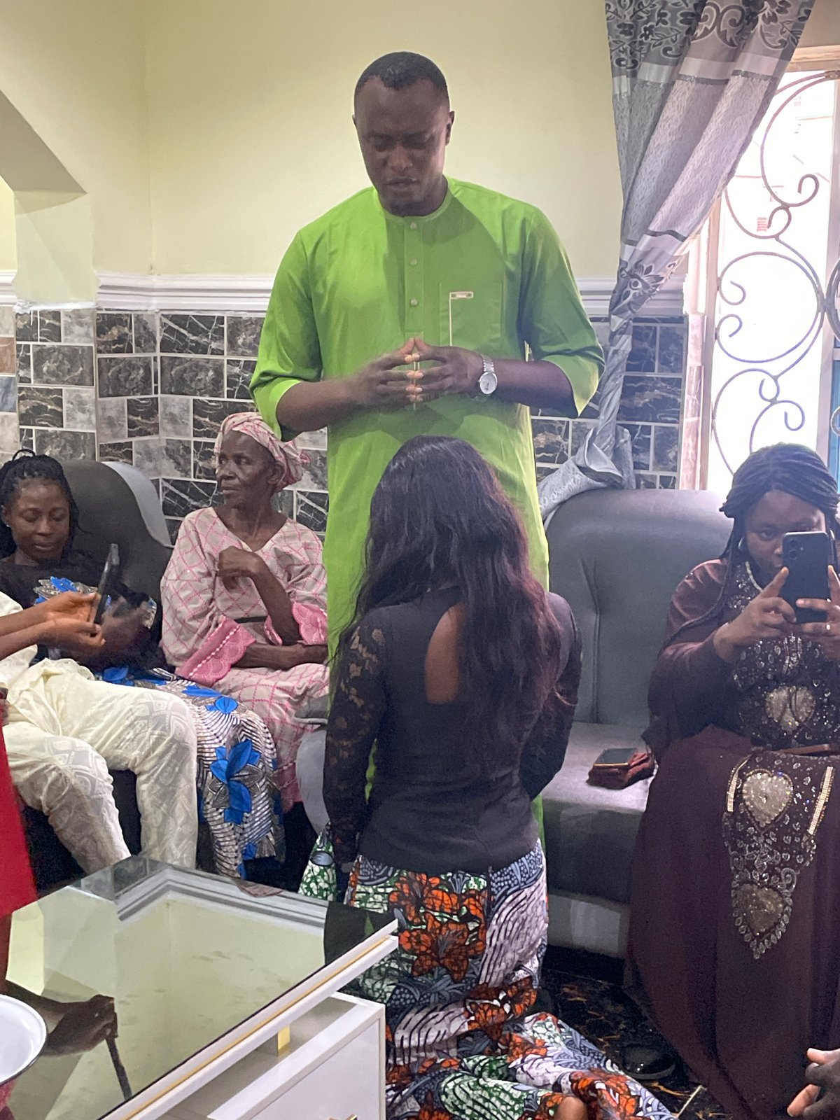 Family celebration at Nigerian home spans indoor and outdoor spaces