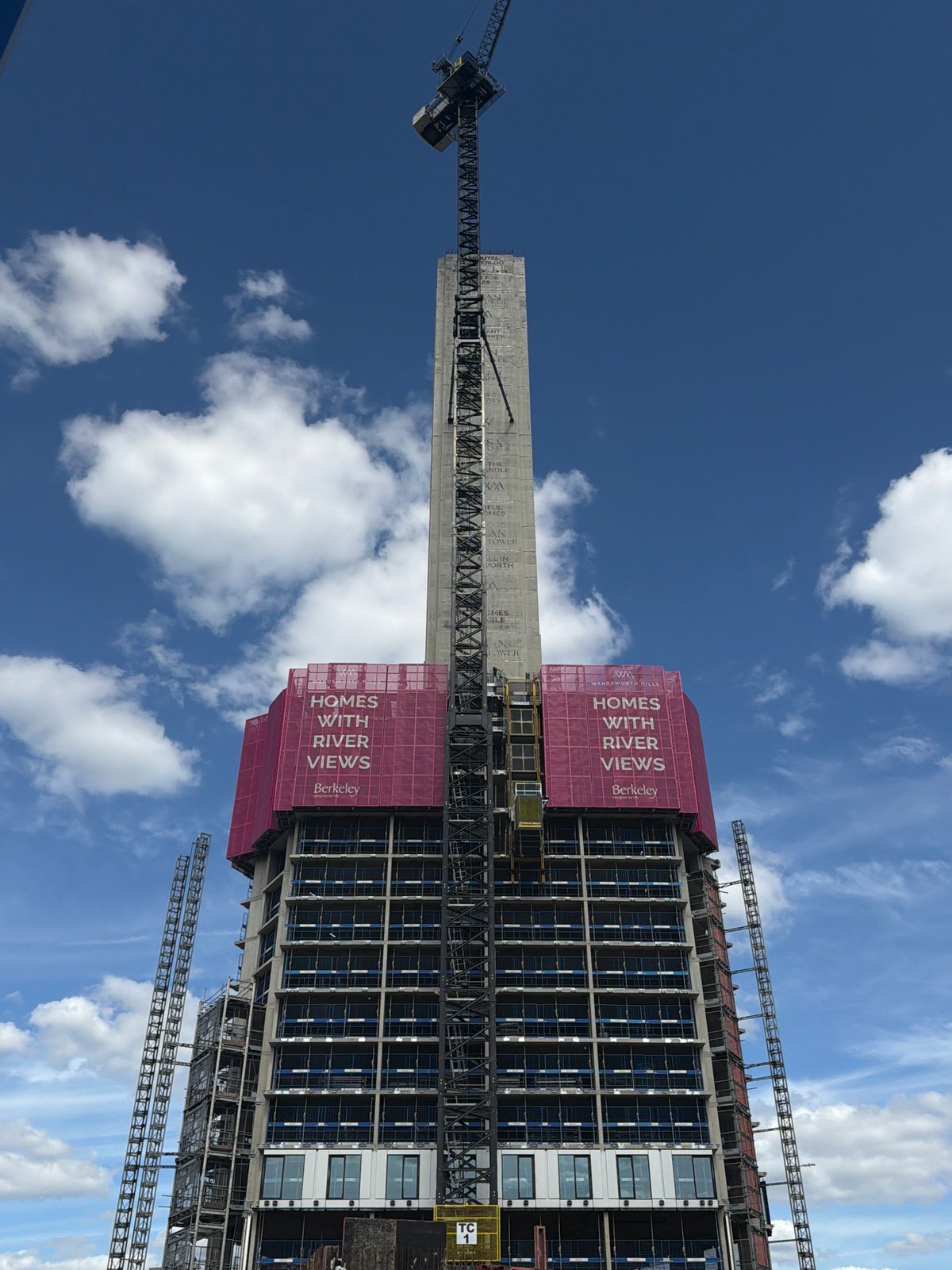 High-rise construction project observed in London with pink scaffolding