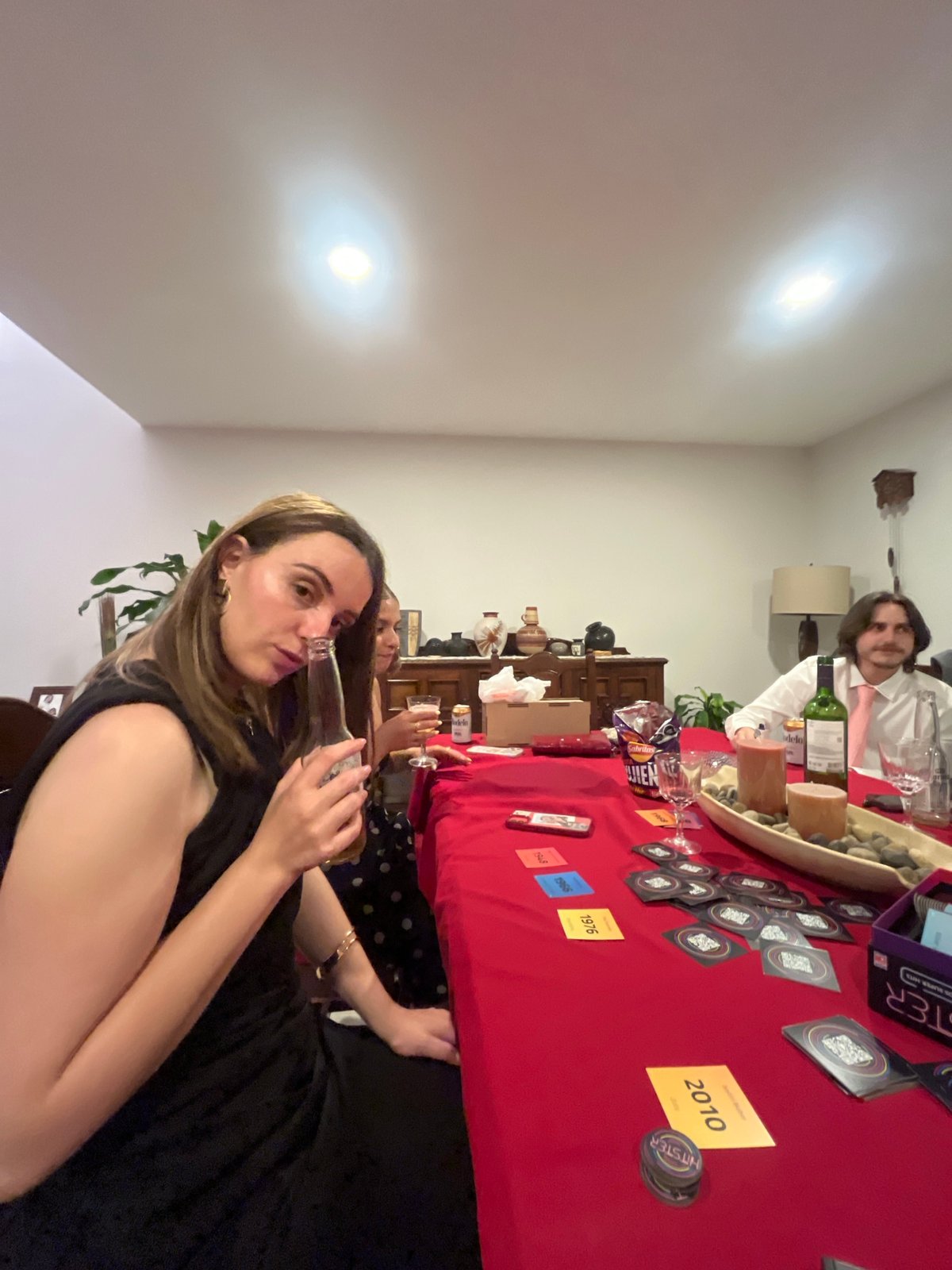 Social gathering around red table in Mexican neighborhood