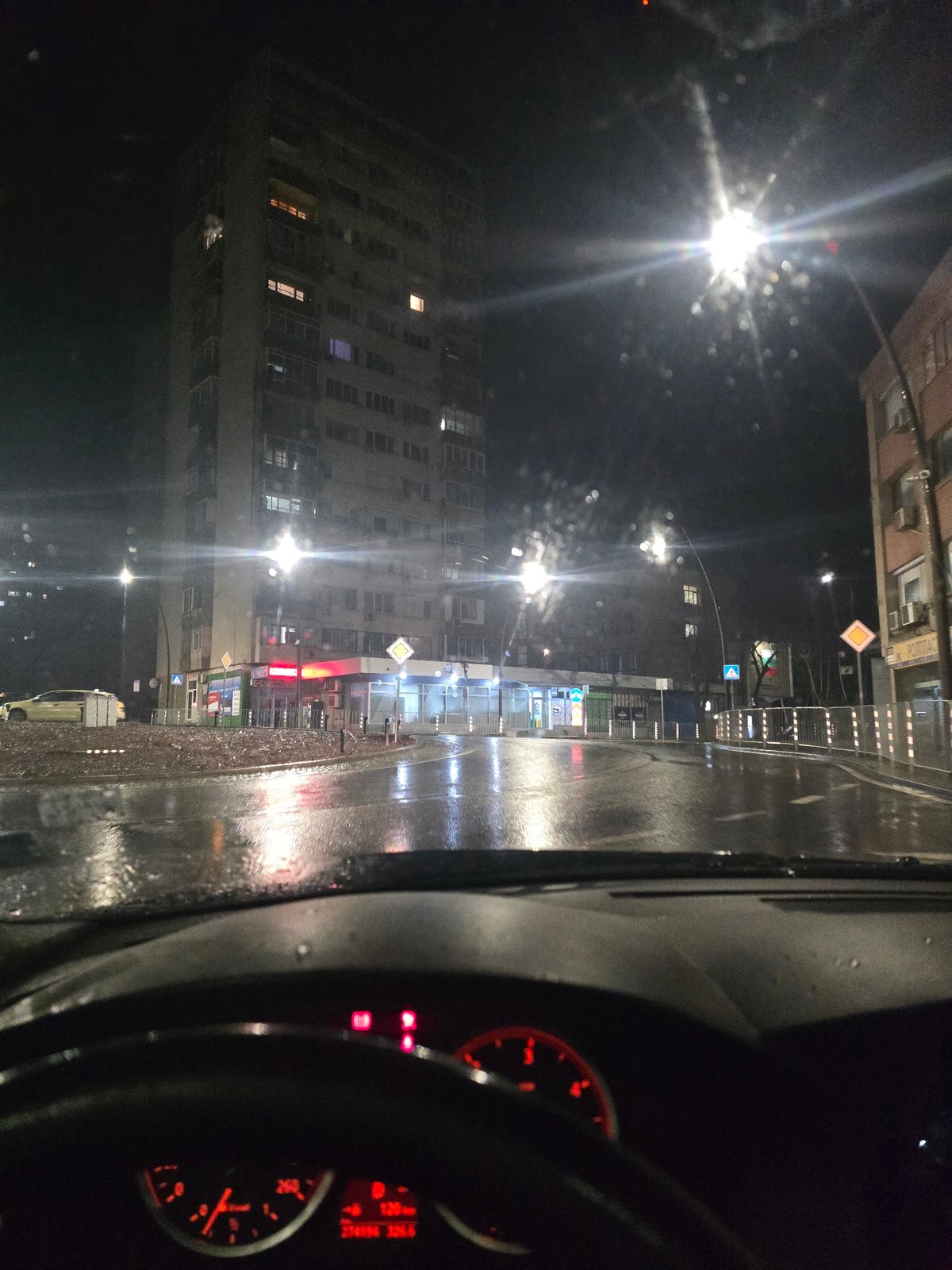 Rainy night drive captured through streets of Yambol, Bulgaria