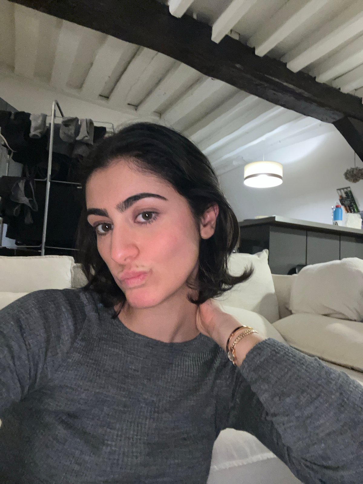 Woman enjoys home dinner and selfie in Paris apartment