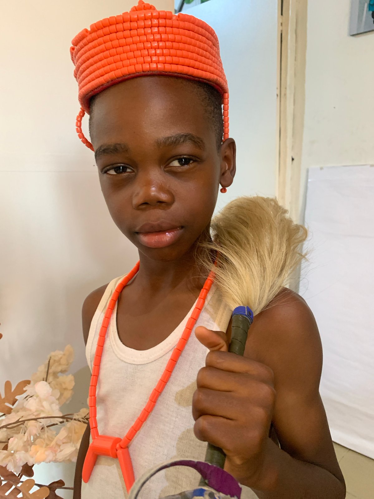 Daily life in Jos blends street scenes with traditional beaded regalia