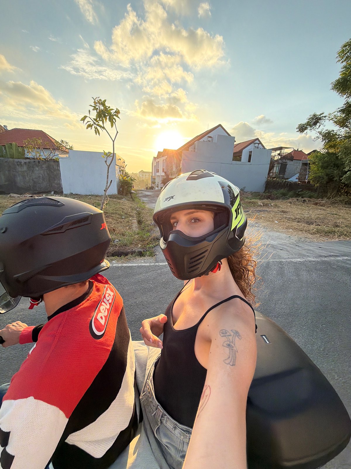 Motorcycle passengers take selfies during North Kuta ride