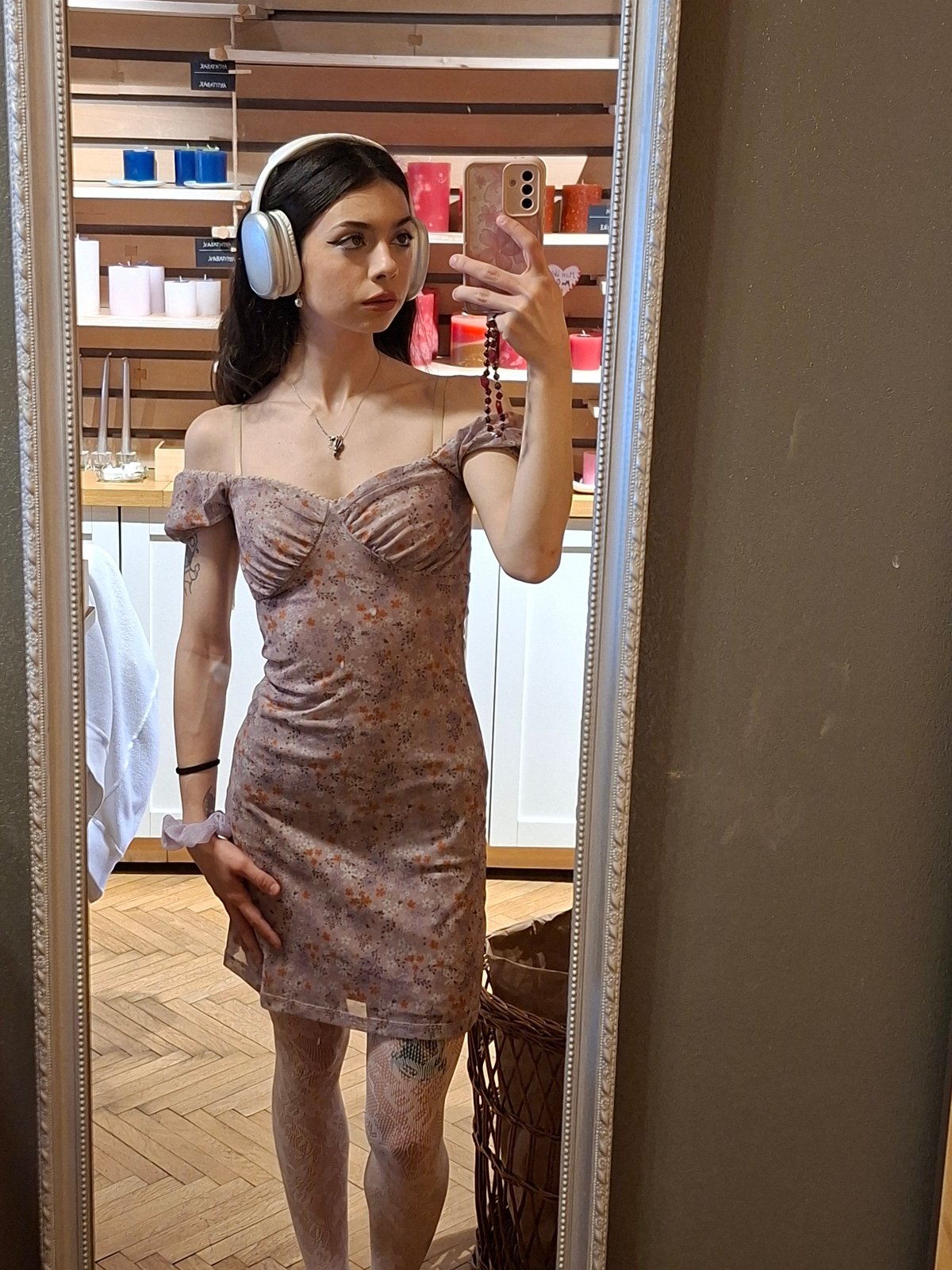 Woman takes mirror selfie with candle display in Sofia