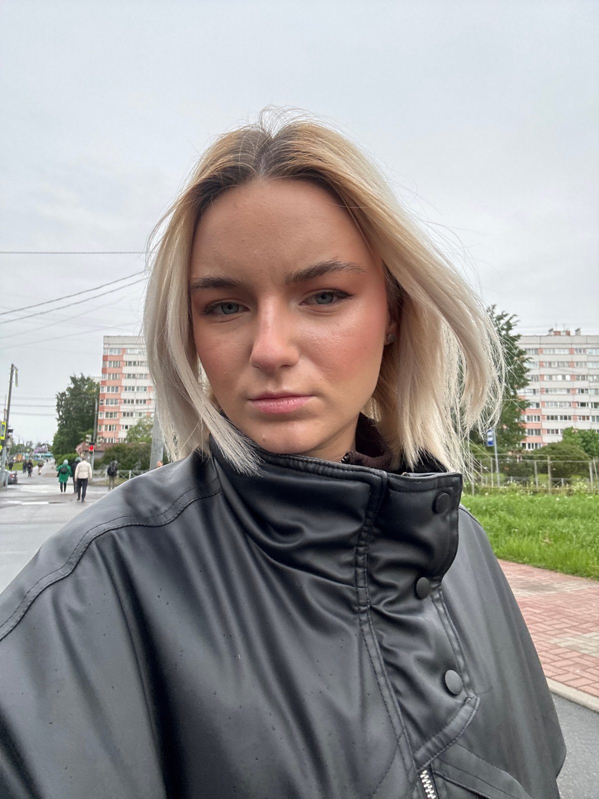Young blonde woman in black jacket photographed in Russia