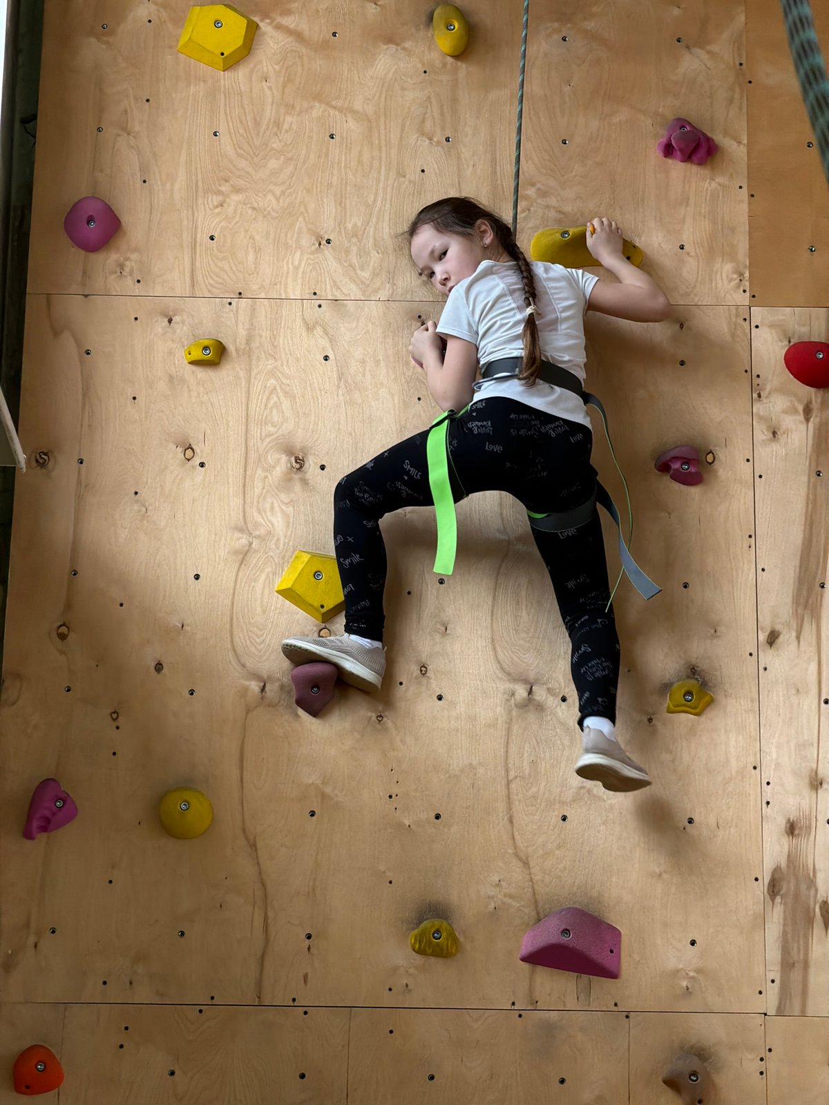 Children practice indoor rock climbing in Izhevsk climbing gym