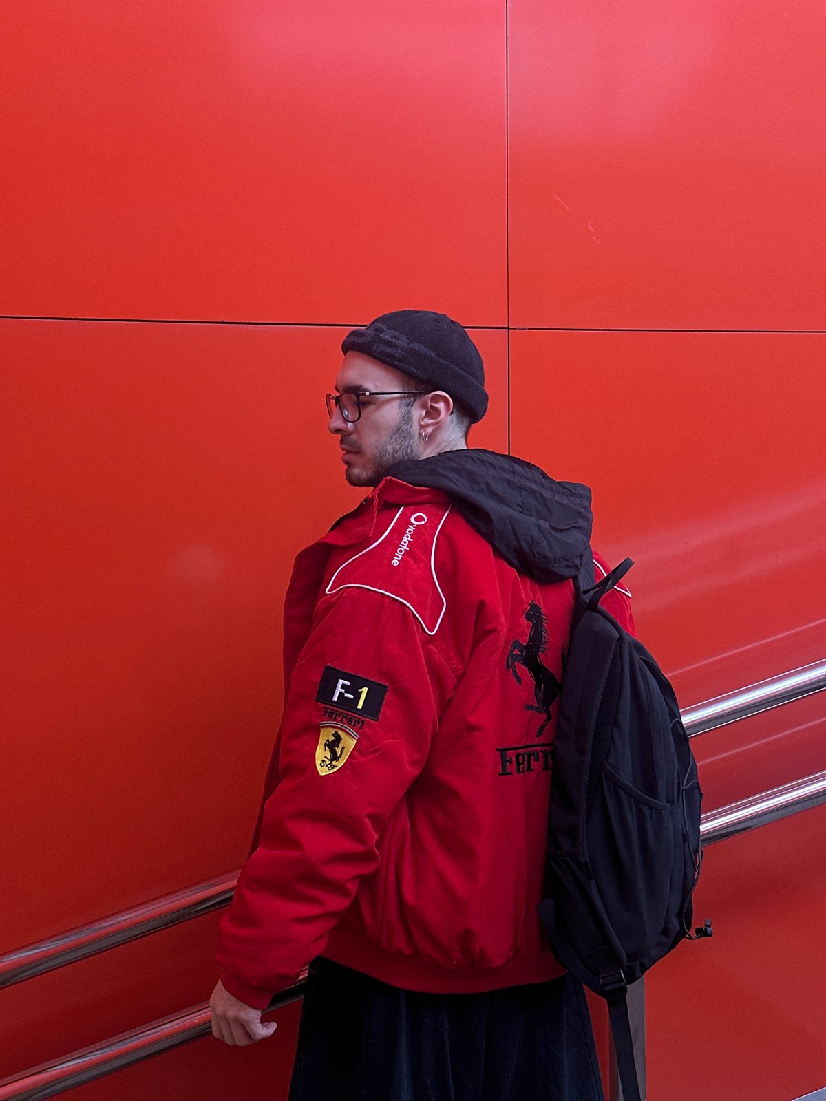 Man in red jacket spotted against orange wall in Moscow