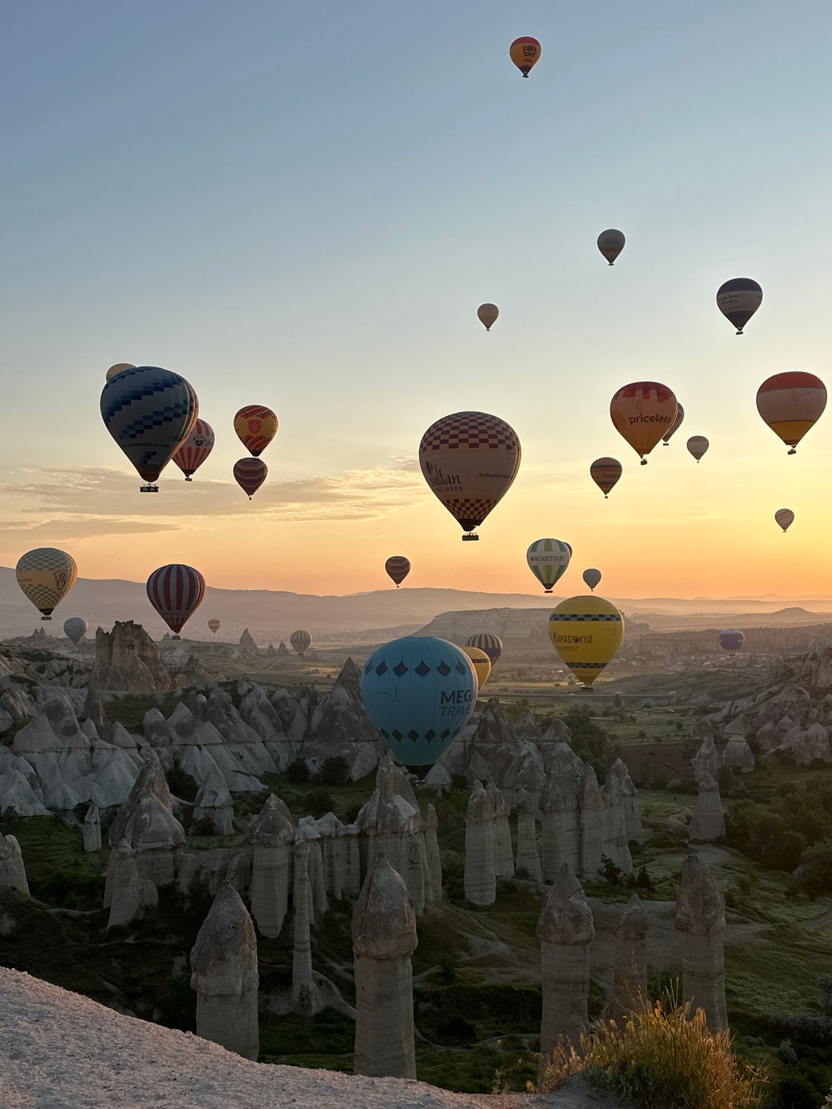 Hot air balloons fill sunrise sky over Cappadocia
