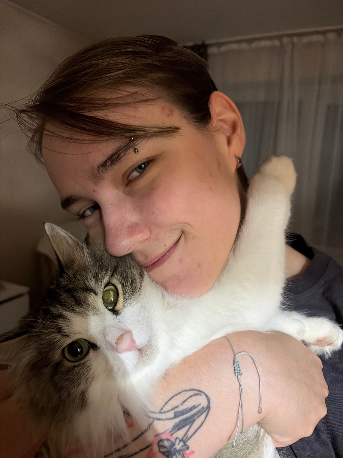 Person with cat photographed indoors in Chaikovsky, Russia
