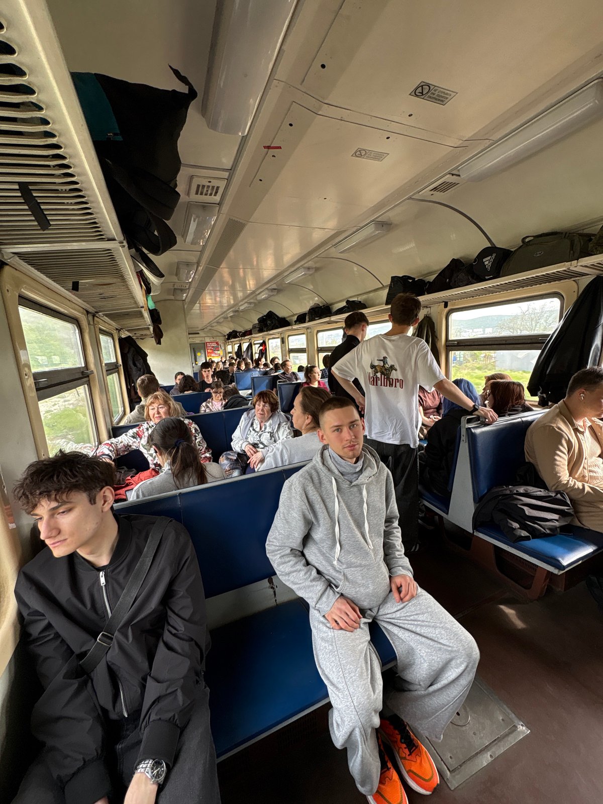 Train passengers observed during daytime journey in Kirillovka, Russia