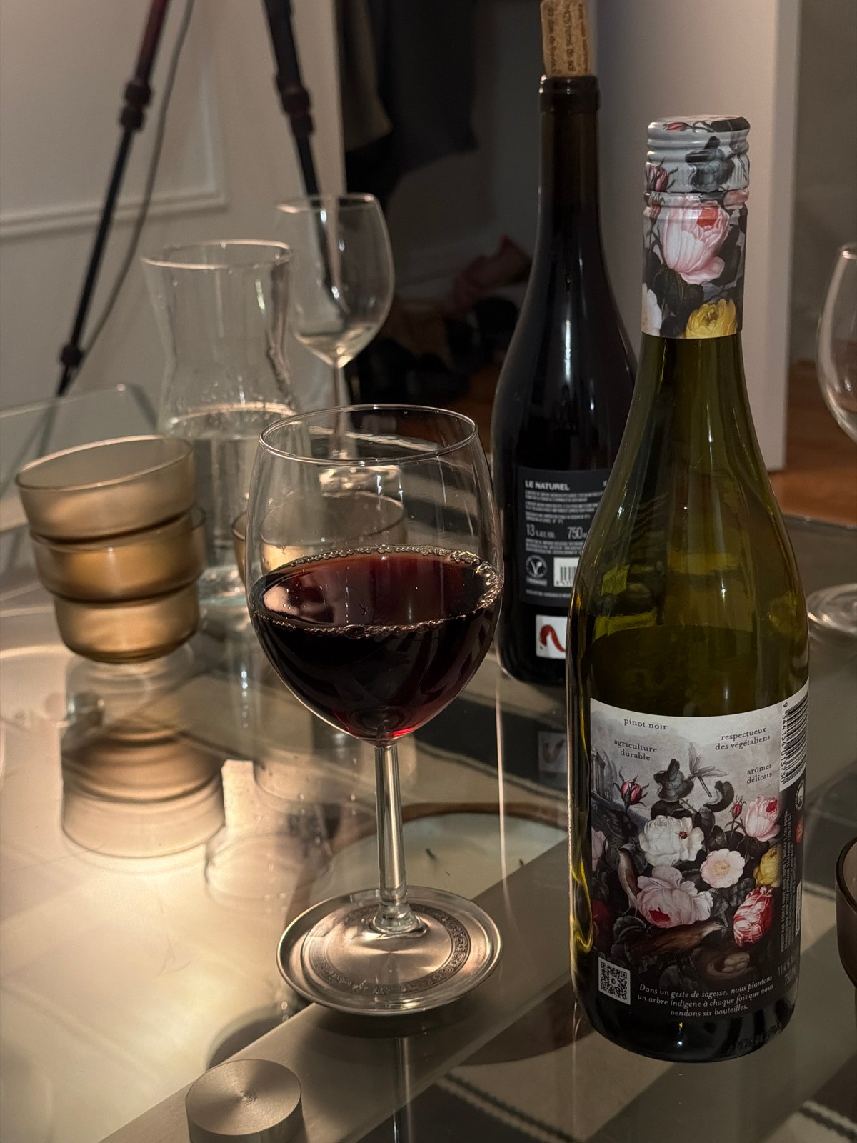 Person enjoys wine while taking smartphone selfies in Montreal