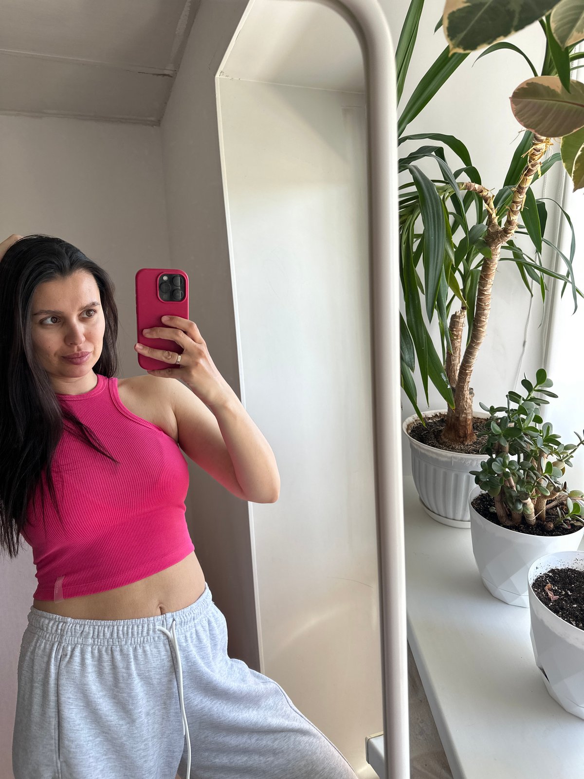 Woman takes morning selfies in pink top, Chaikovsky