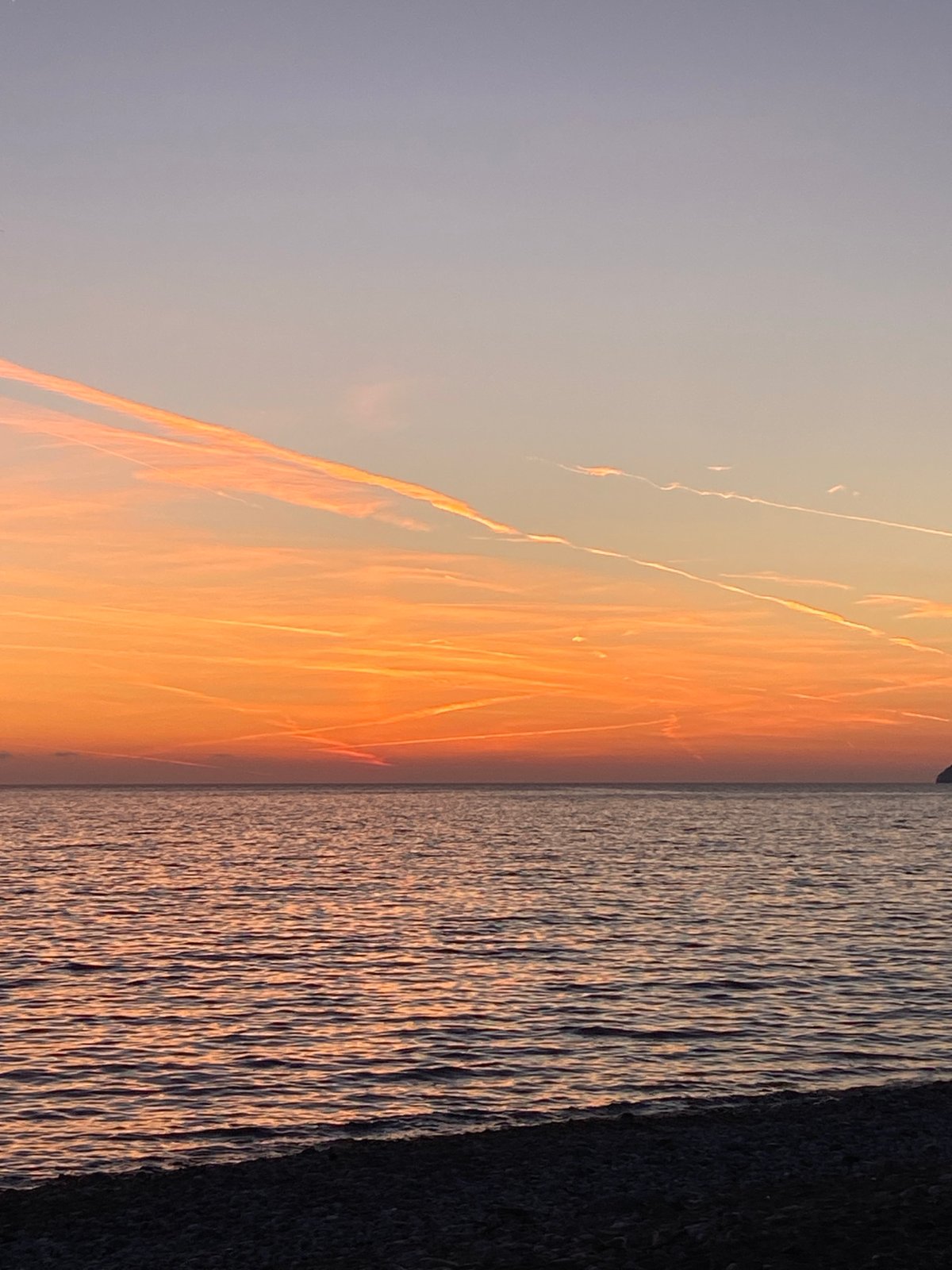 Young man walks waterfront paths during sunset in Bar, Montenegro