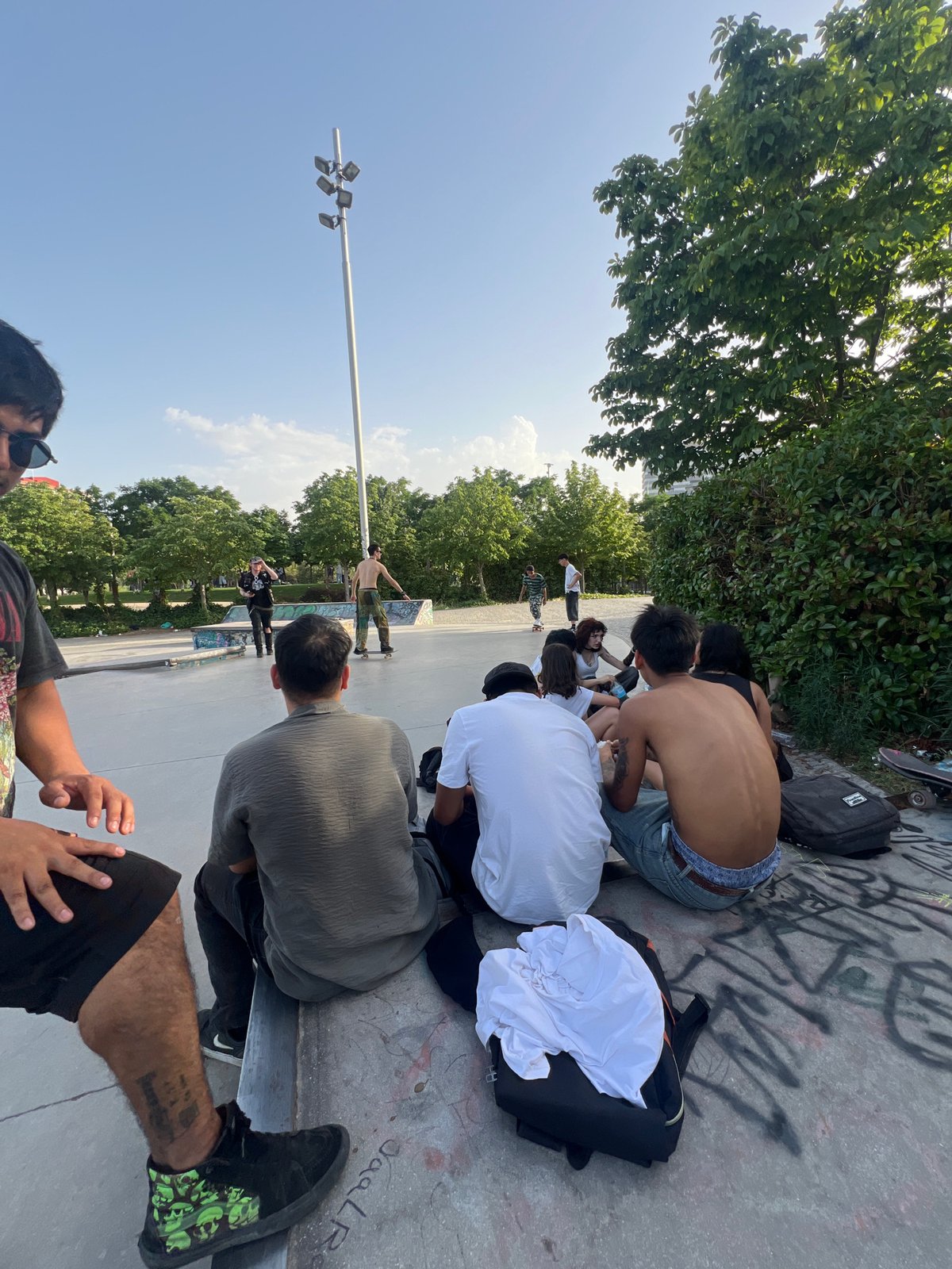 Skaters and friends wind down a summer evening in Madrid park