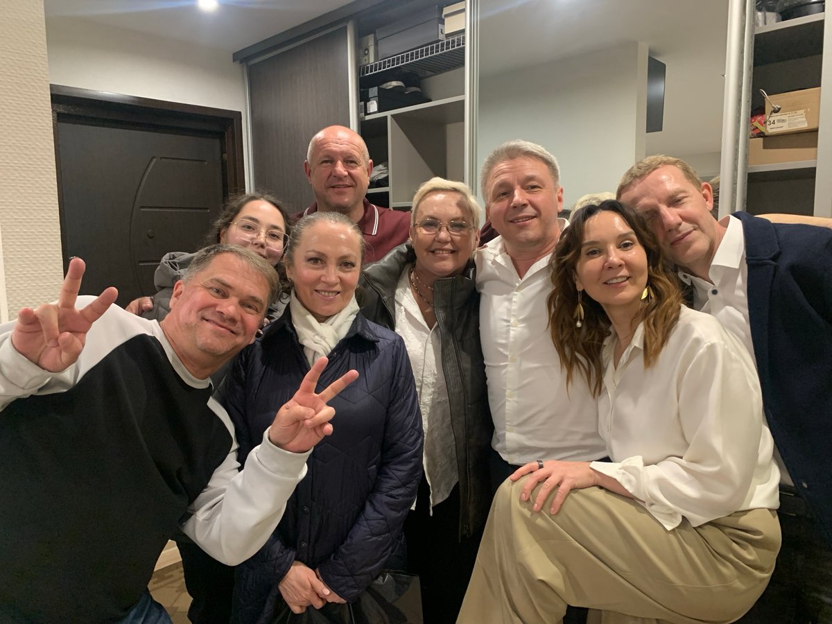 Eight people gather for group photo in Chaikovsky home