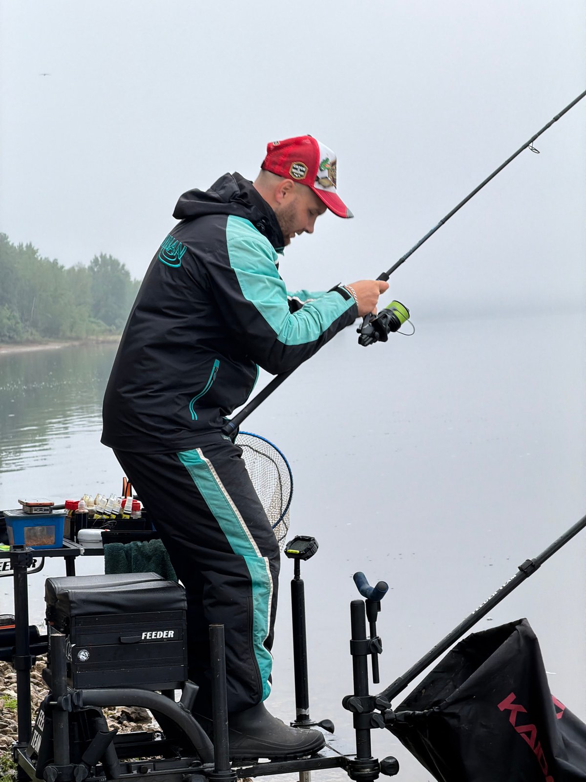 Early morning angler fishes calm waters in Noviy, Russia
