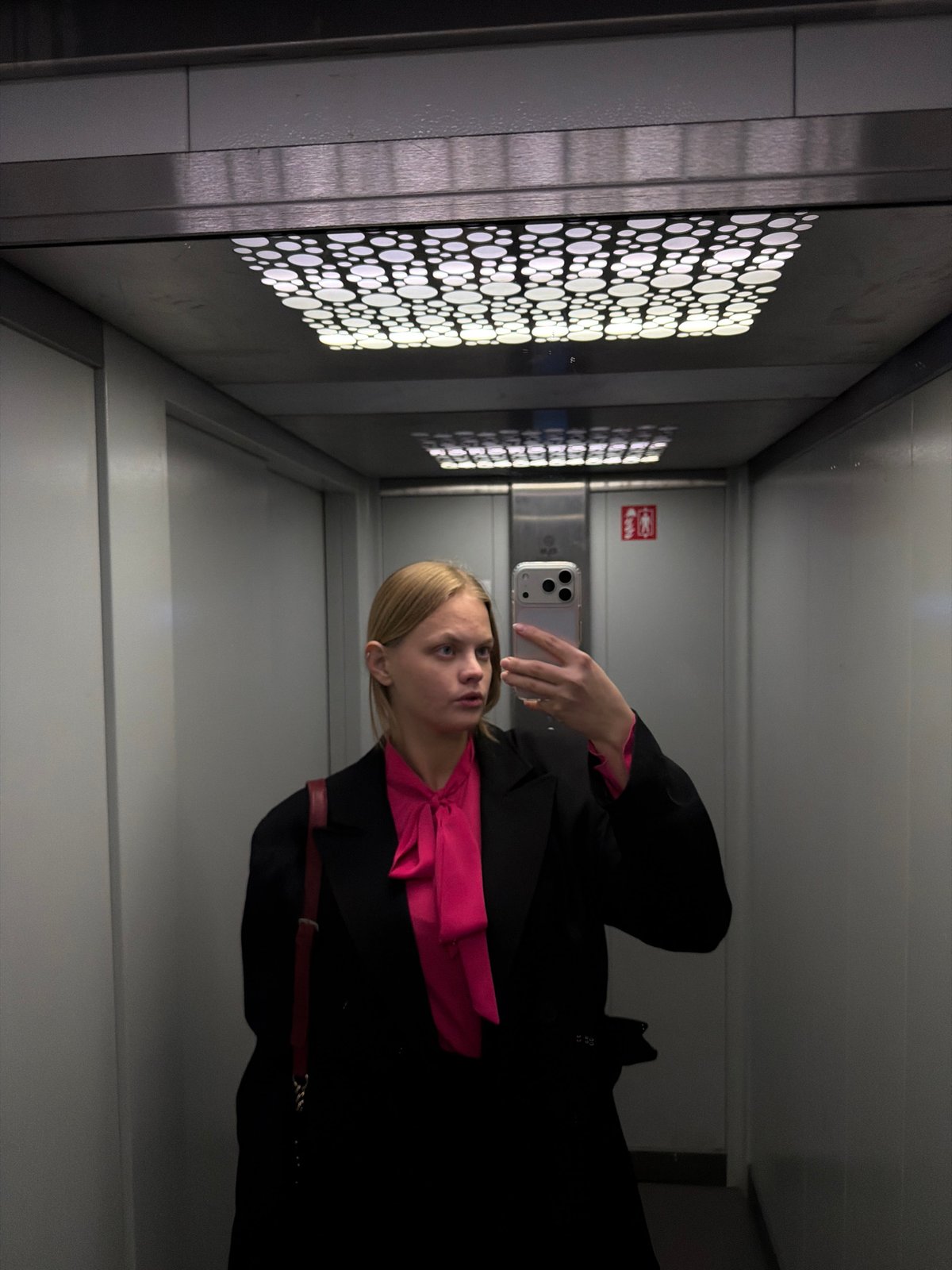 Woman takes multiple selfies across indoor locations in Izhevsk