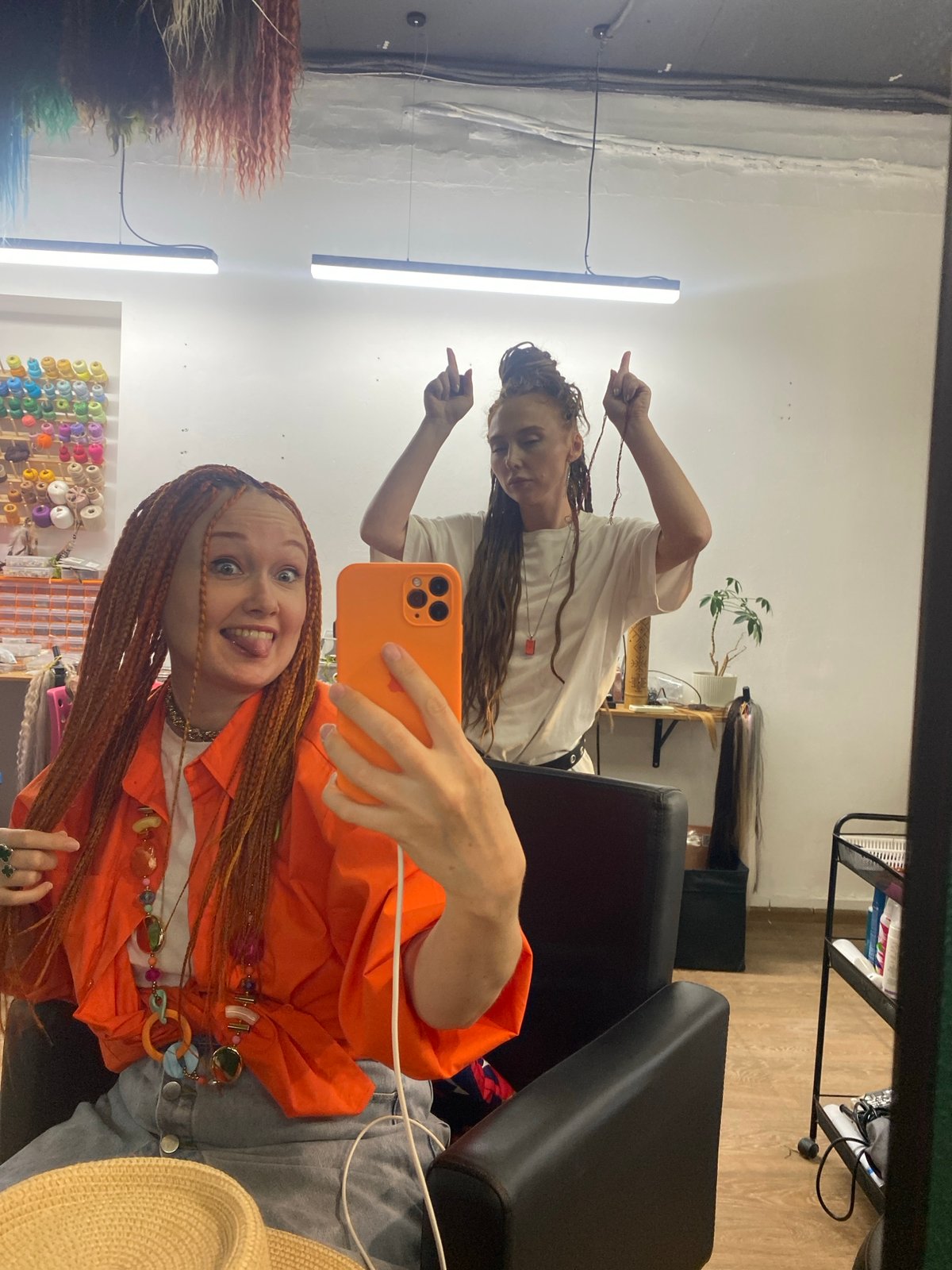Woman captures salon selfie with orange braids in Sochi