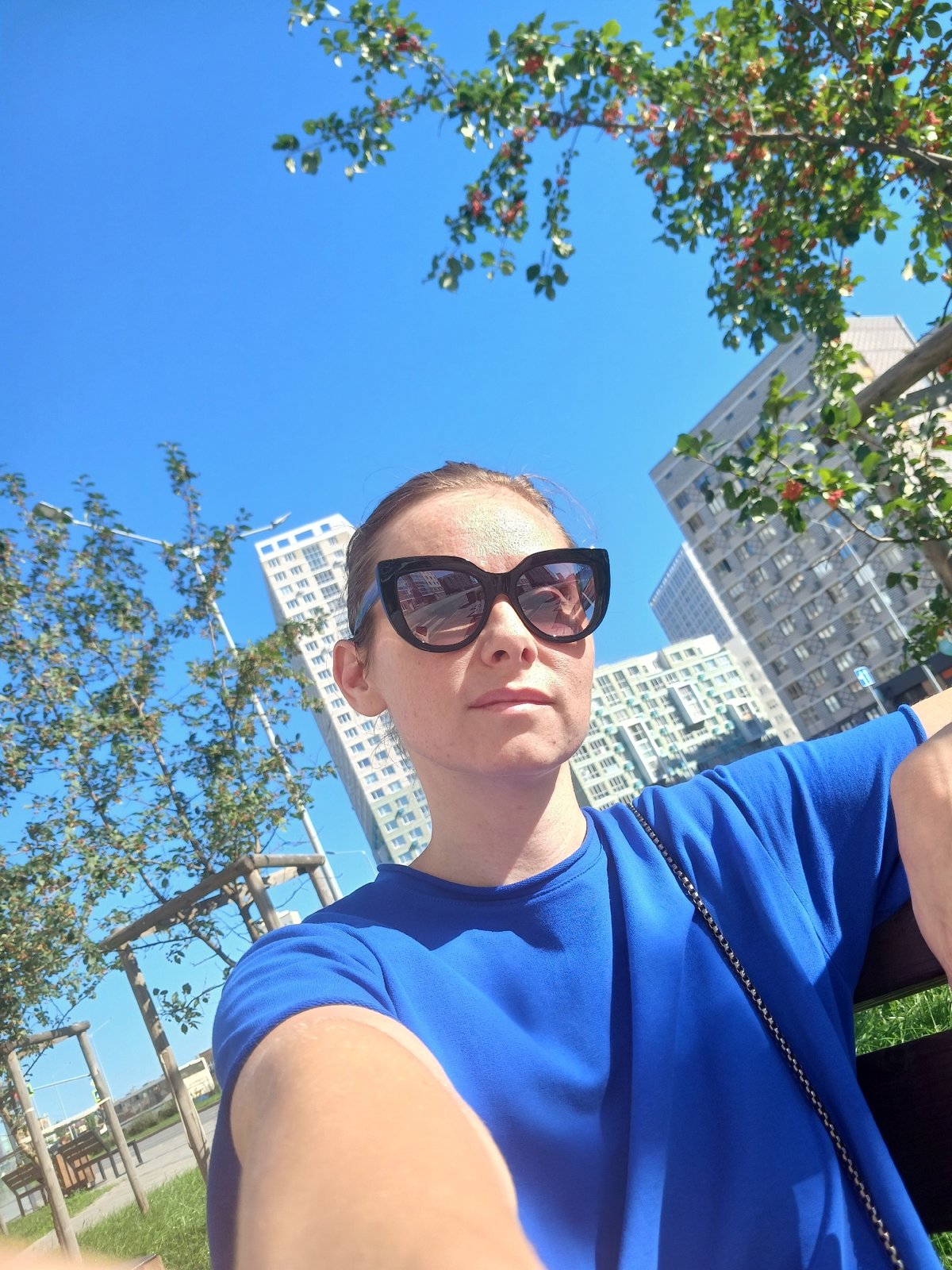 Sunny selfie session near Yekaterinburg apartments, blue outfit
