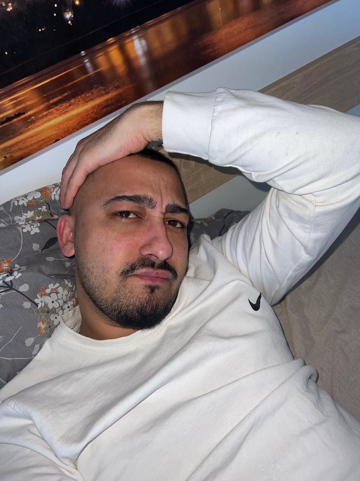 Man rests on bed in Shumata, Bulgaria