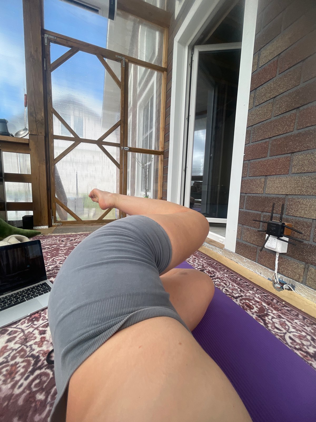 Woman conducts online yoga session in Russian greenhouse space