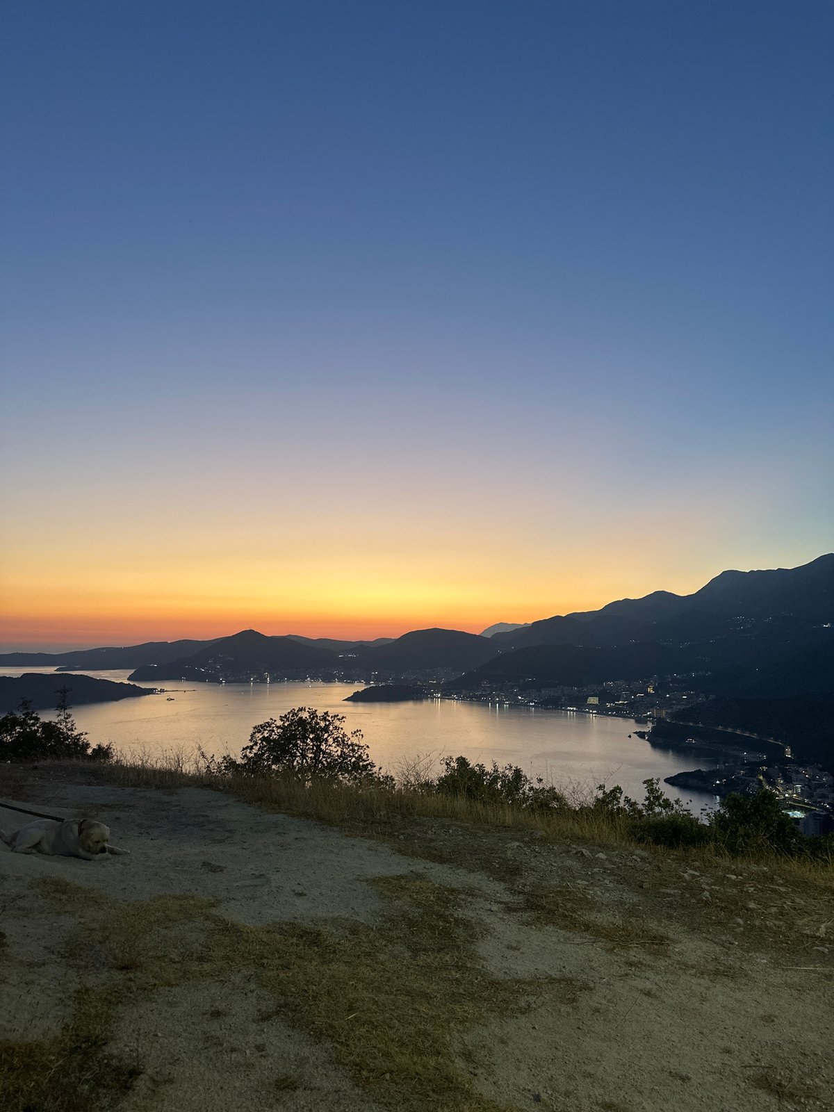 Twilight panorama over Sveti Stefan's mountain-meet-sea coastline