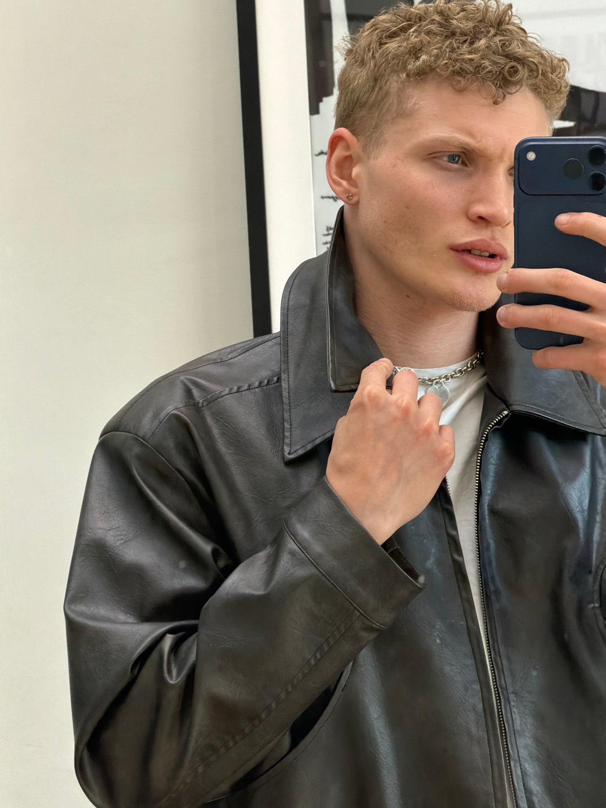 Young man takes selfies indoors in London