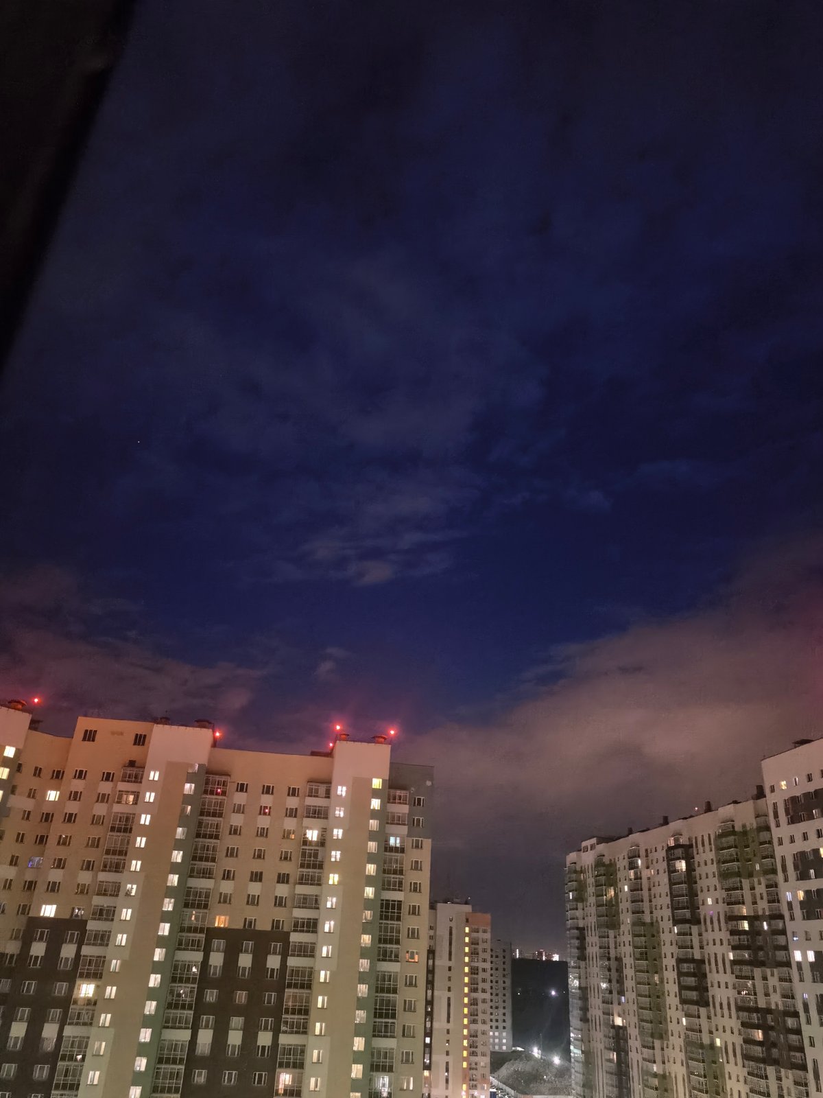 Dusk aerial views of a residential complex and rocket launch
