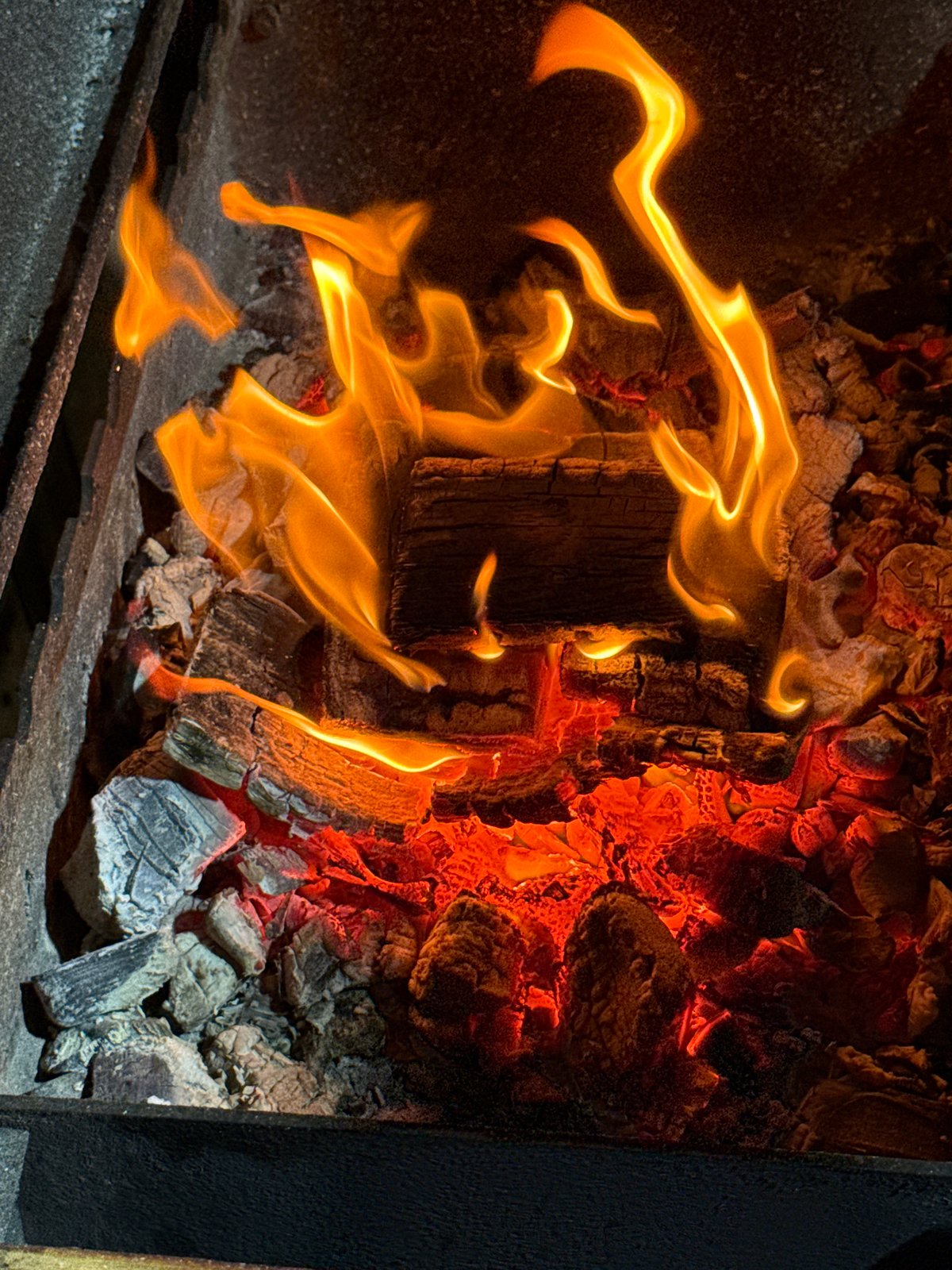 Bacon-wrapped bites prepped over a live charcoal grill in Kamyshin