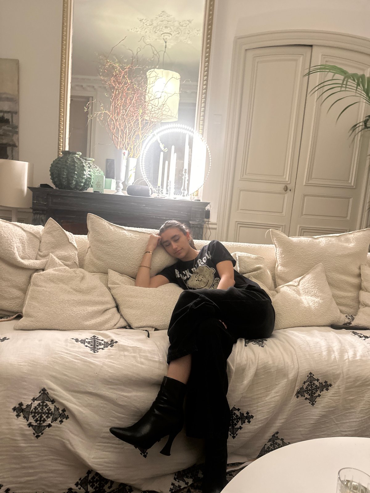 Woman rests on sofa in Paris interior setting