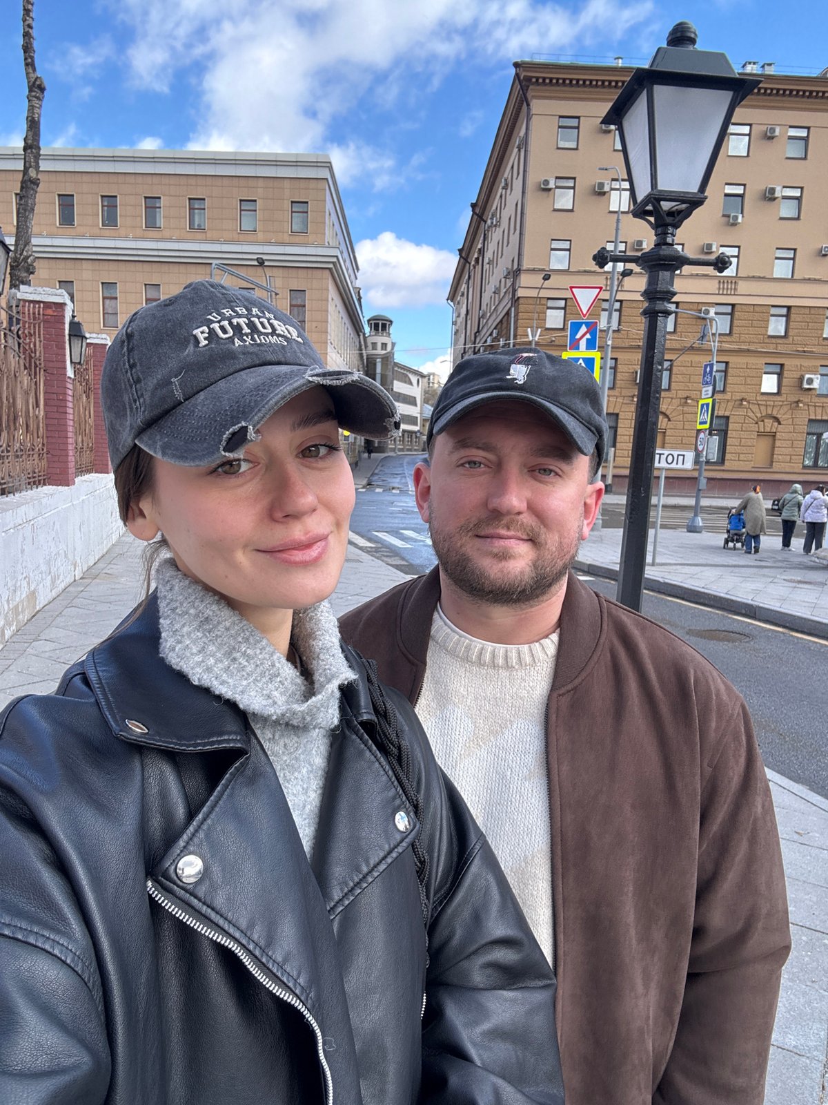 Tourists photograph themselves near historic Moscow building