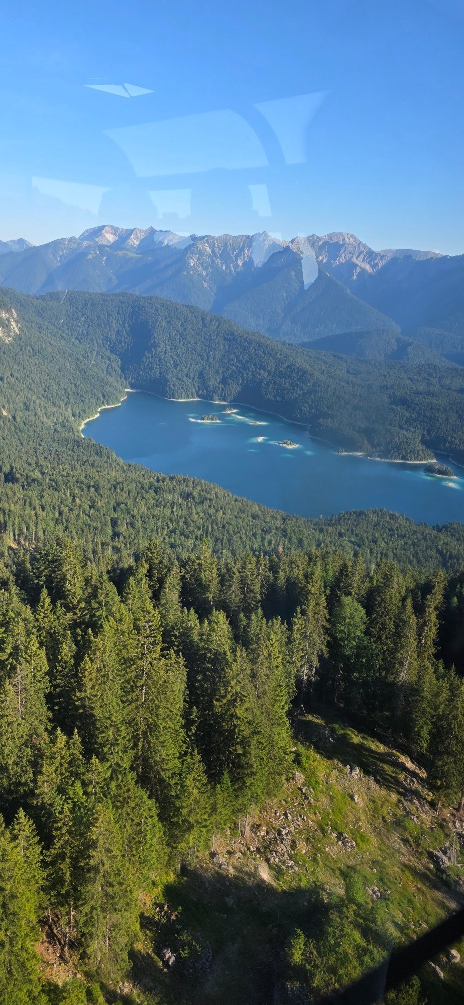 Eibsee lake from ground and air on a clear Alpine morning