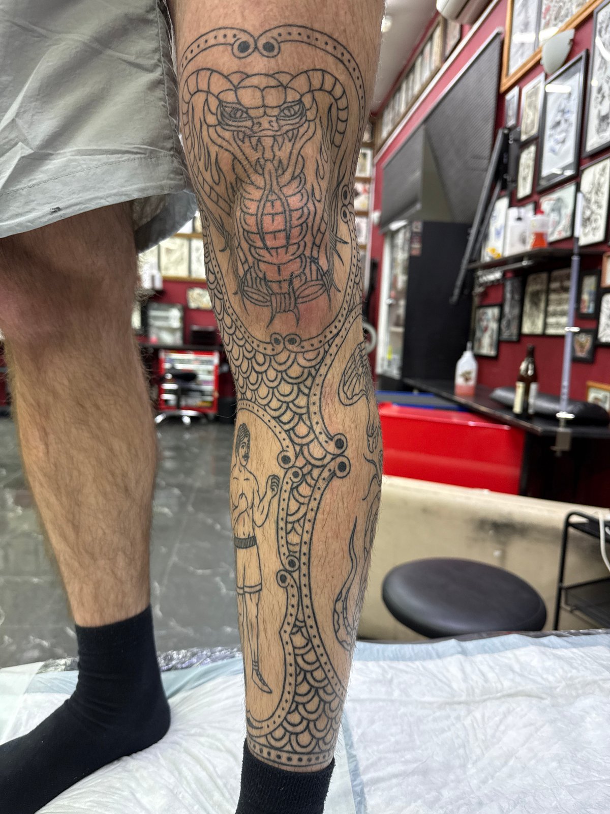 Person displays intricate leg tattoo work in Moscow studio