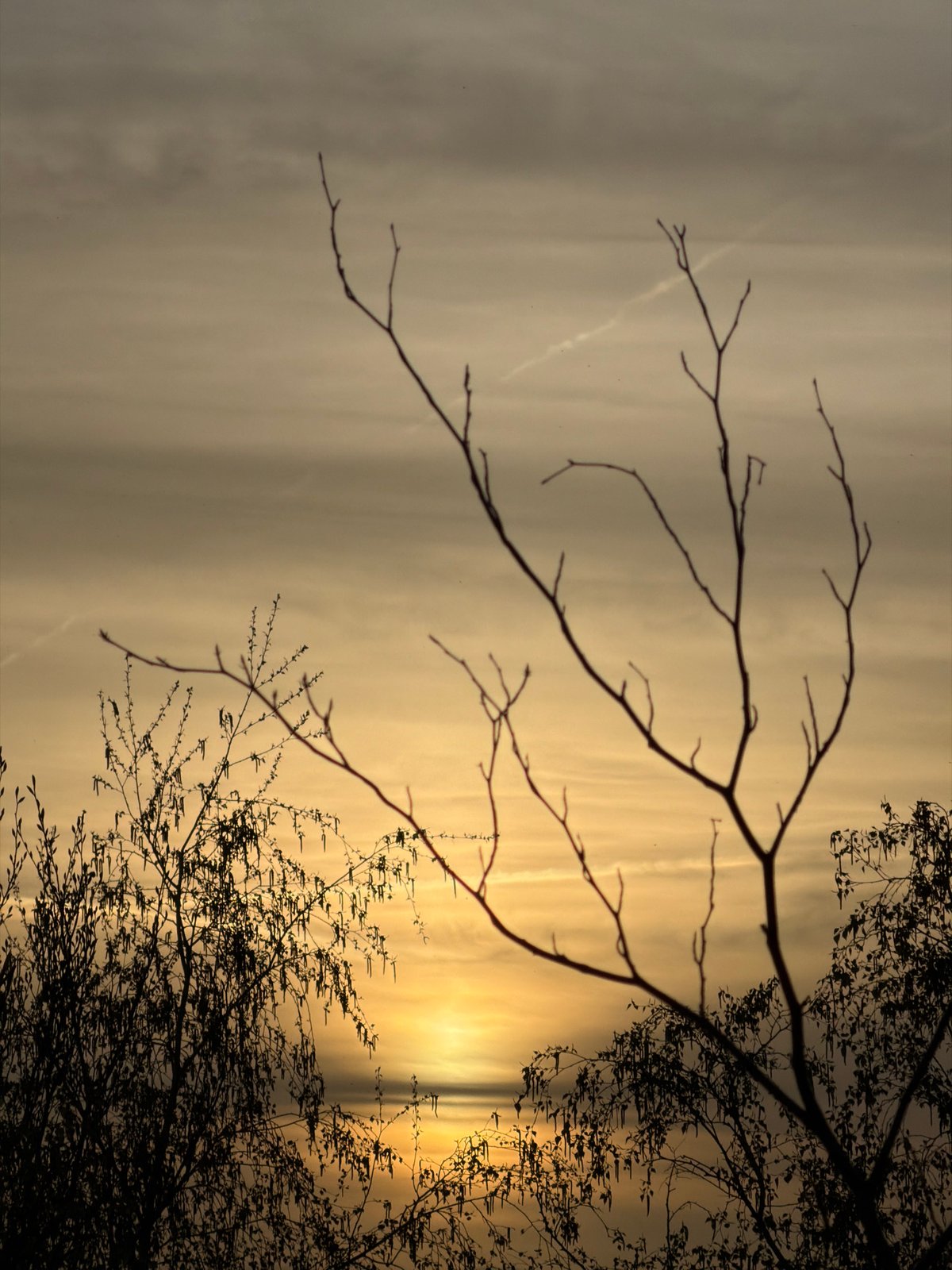 Hazy sunset observed through clouds in Schifflange, Luxembourg