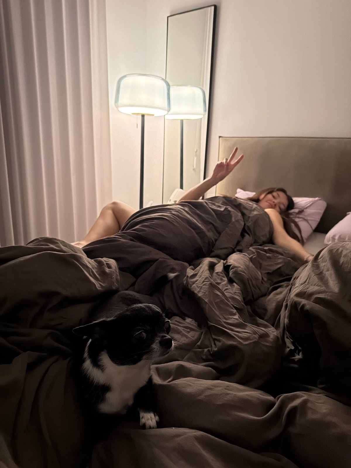 Woman and dog share peaceful moment in Tel Aviv bedroom