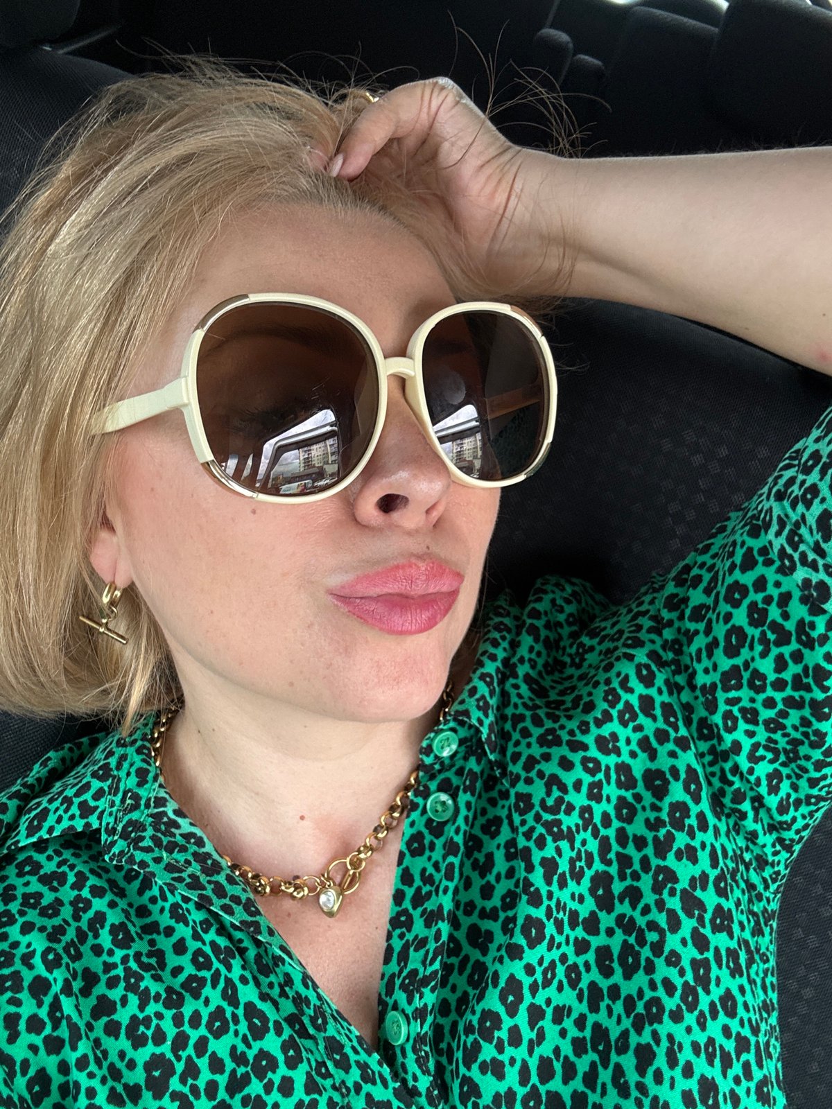 Car selfie session in Sochi, green leopard print and sunglasses.