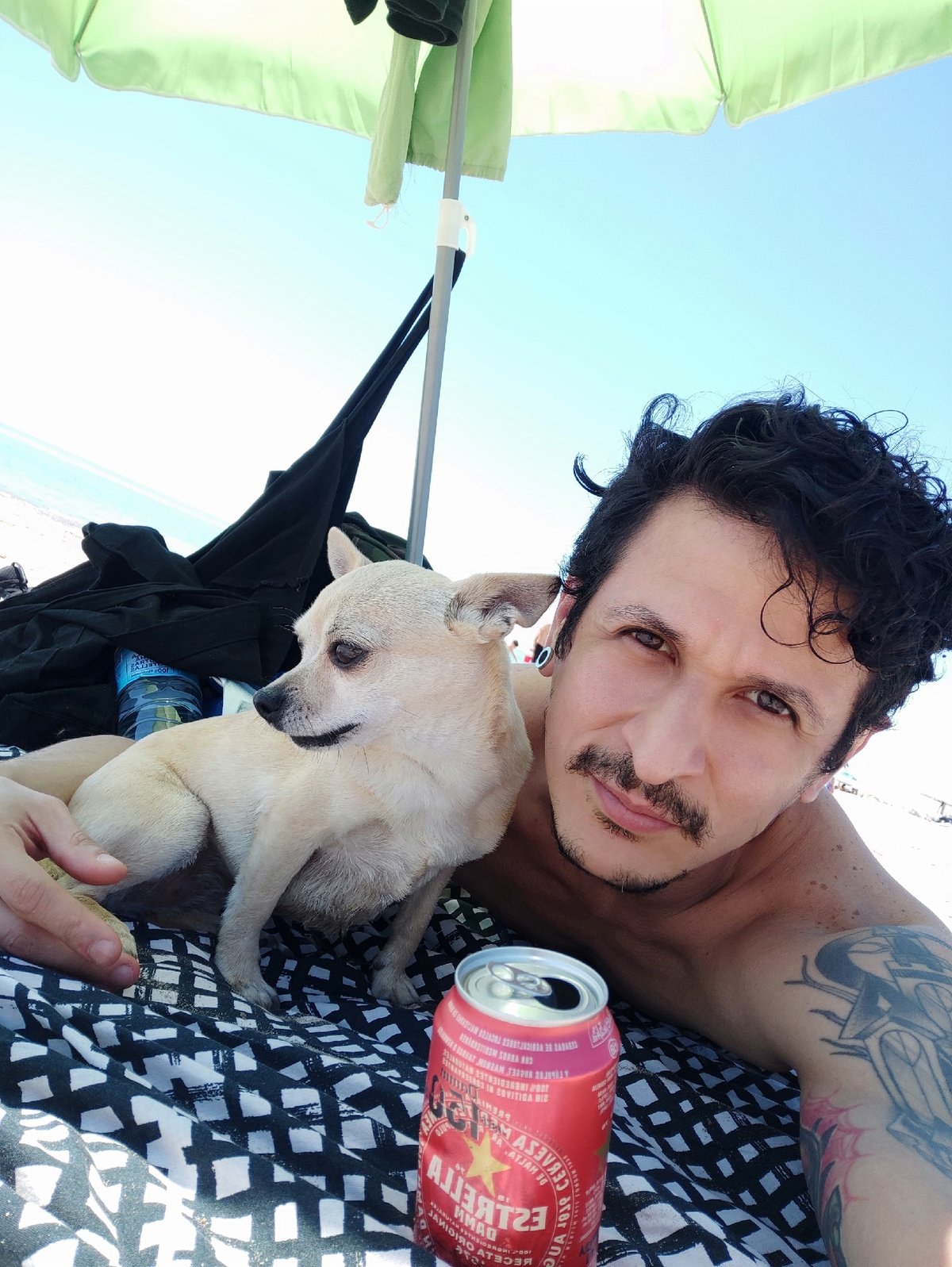 Man and dog enjoy sunny day at Castelldefels beach
