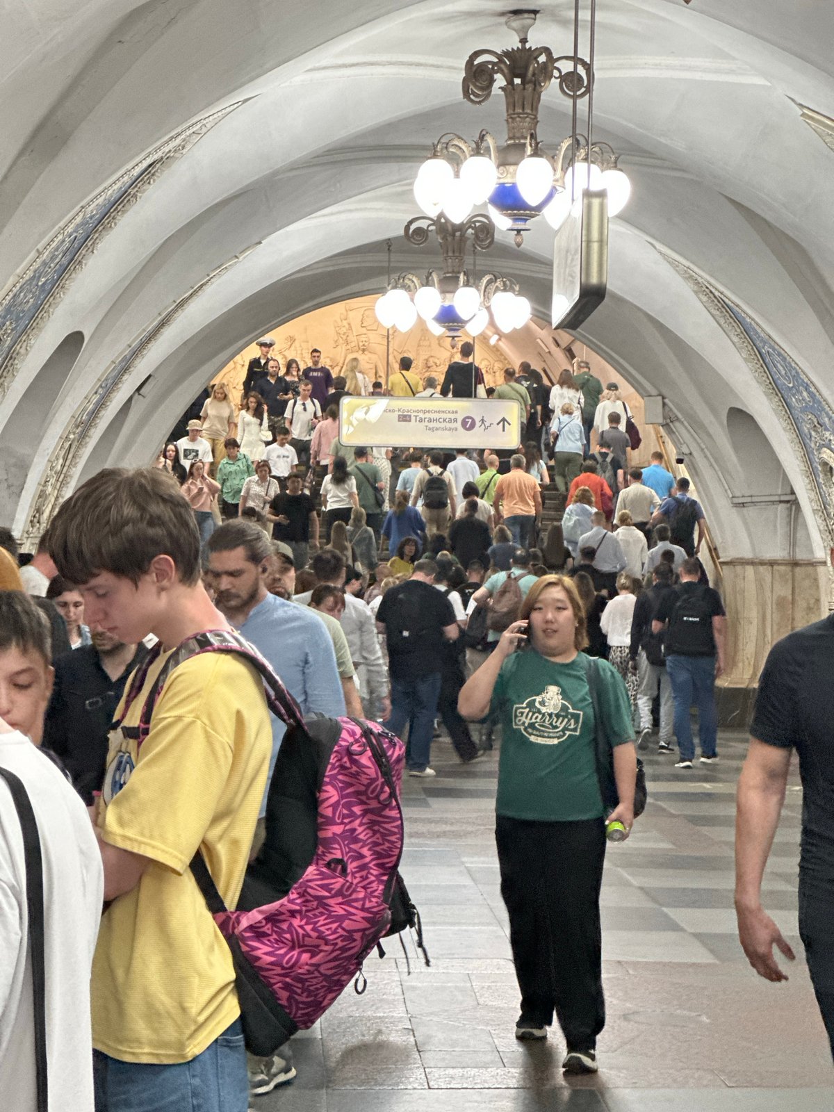 Moscow residents navigate metro station and street art corridor