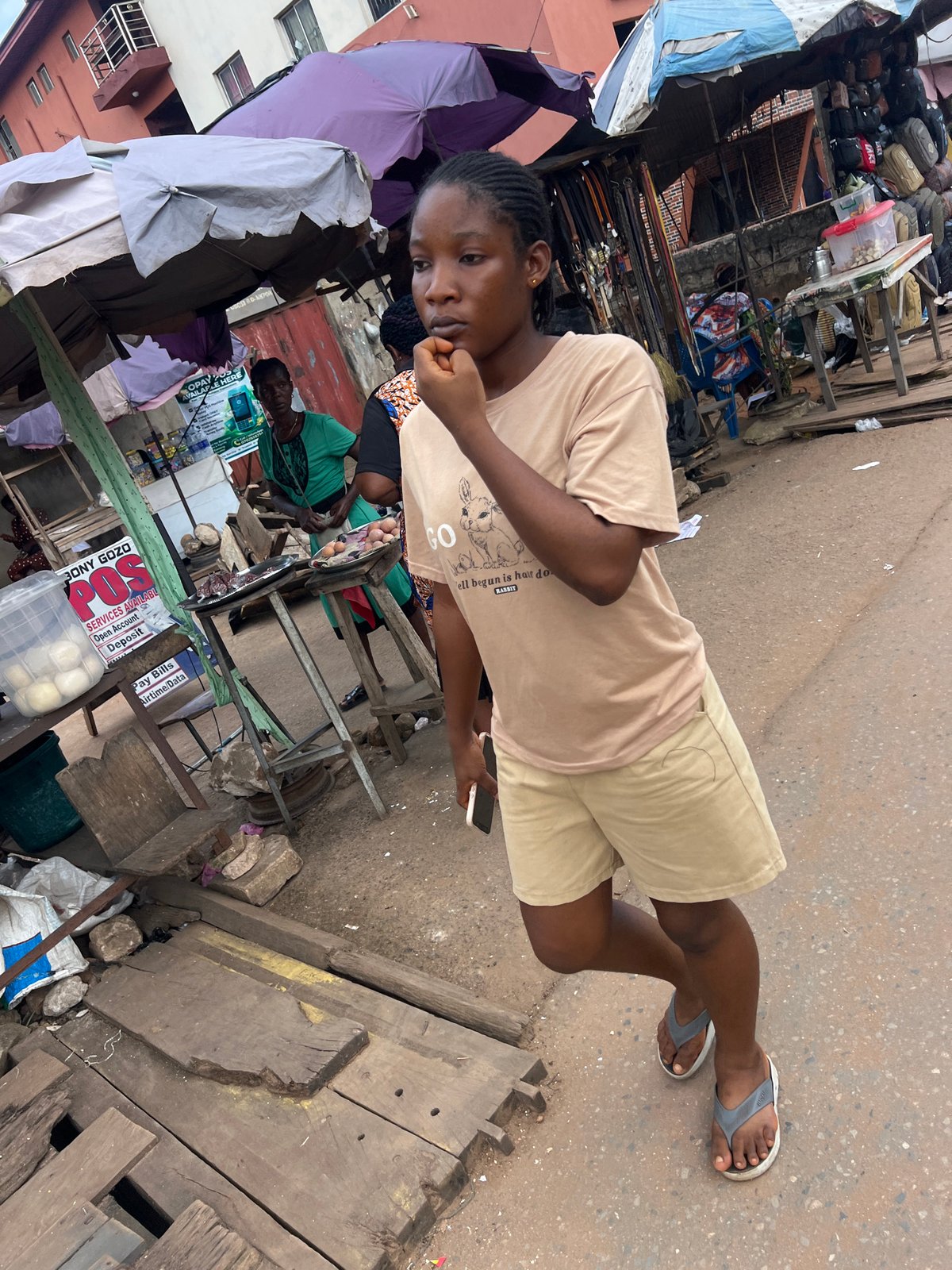 Midday street commerce and everyday movement in Nkpor, Nigeria