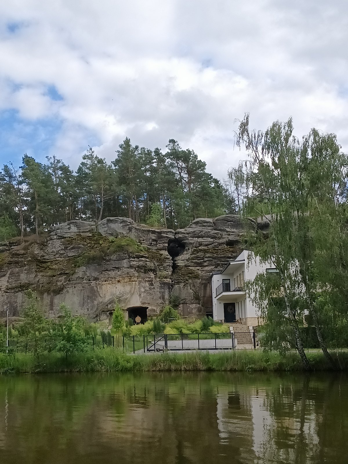 Sandstone cliffs, forest lake, and overcast skies in Nová Ves