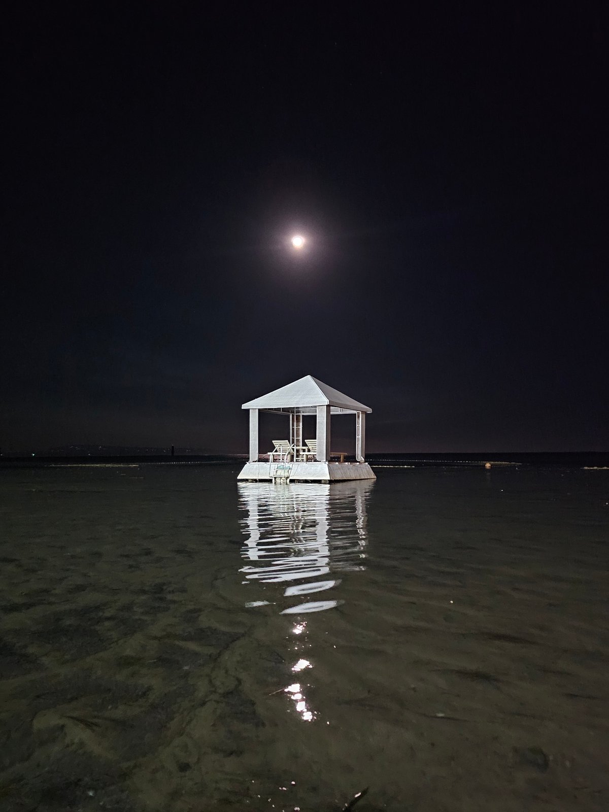 Full moon night at a floating gazebo off Denpasar's waterfront