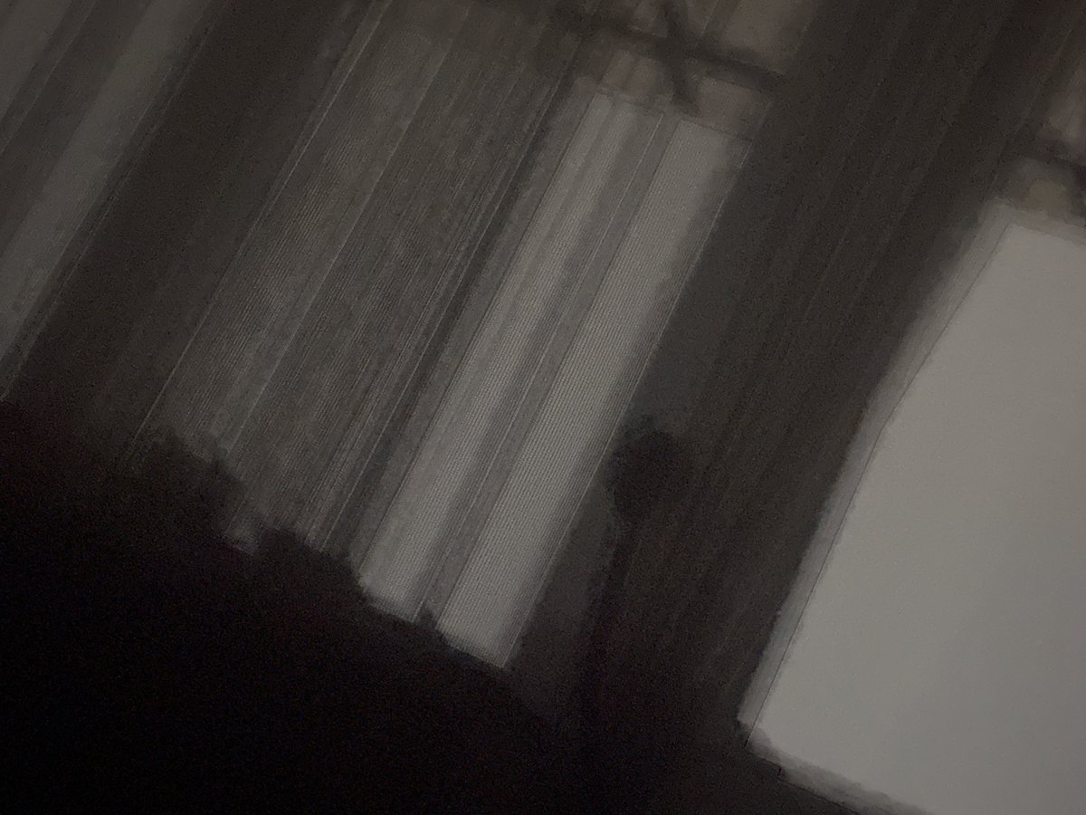Low-angle indoor scene shows vertical patterns in darkened space