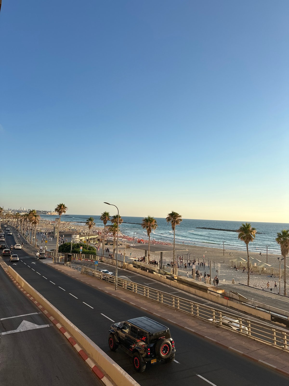 Tel Aviv beachfront buzzing on a golden summer afternoon